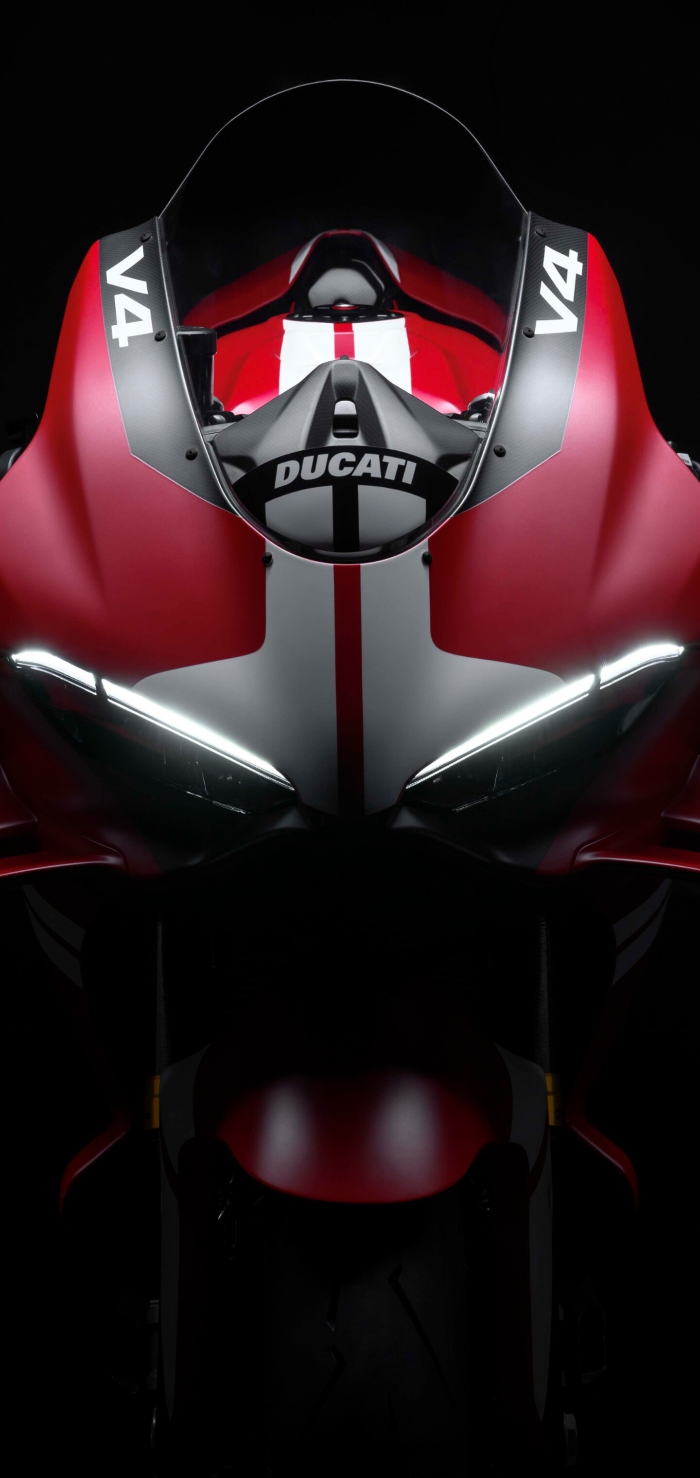 Cinematic close-up of a Ducati Superleggera V4 Centenario sports bike in a dark studio setting.