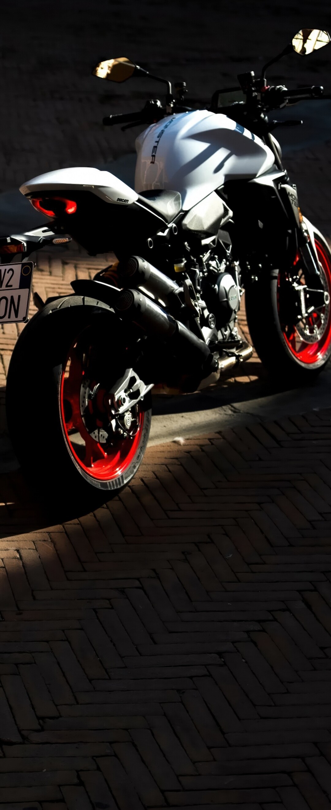 A sleek and futuristic 2026 Ducati Monster V2 sports motorcycle in a high-quality render.