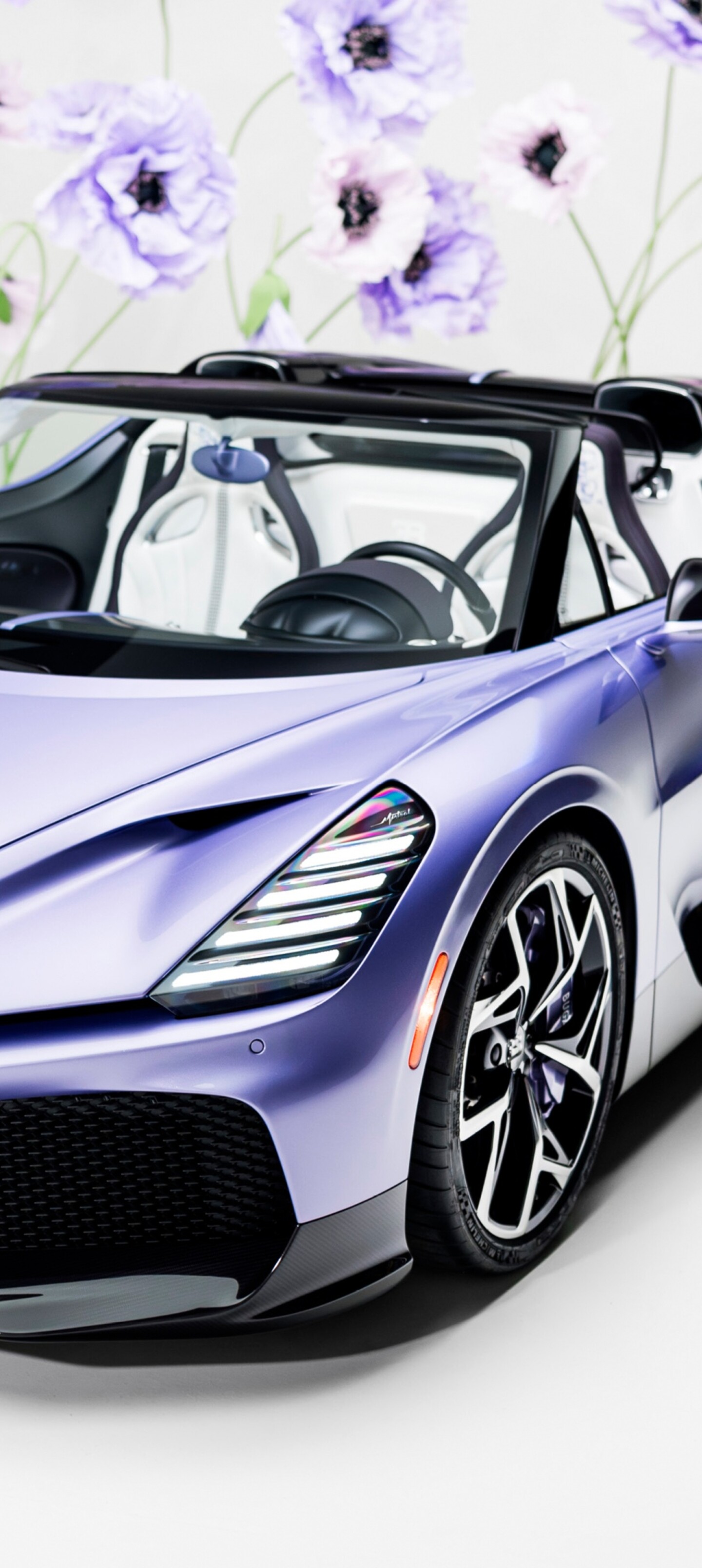 A sleek, futuristic one-off roadster car with a deep purple aesthetic and aerodynamic body.