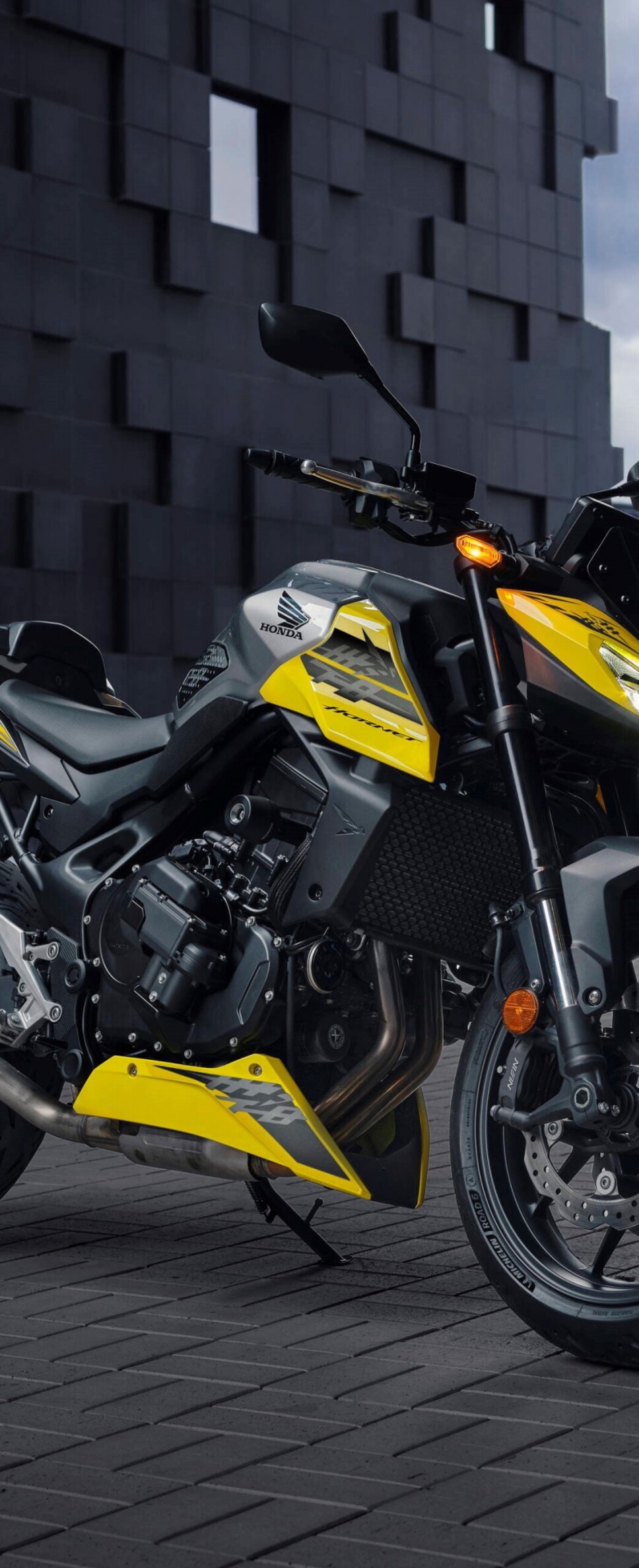 A modern 2026 Honda CB750 Hornet motorcycle parked outdoors in a contemporary landscape.