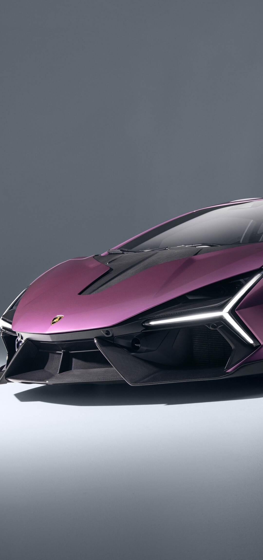 A highly detailed, cinematic shot of the 2026 Lamborghini Revuelto featuring its sleek aerodynamic body and sharp, modern headlight design.