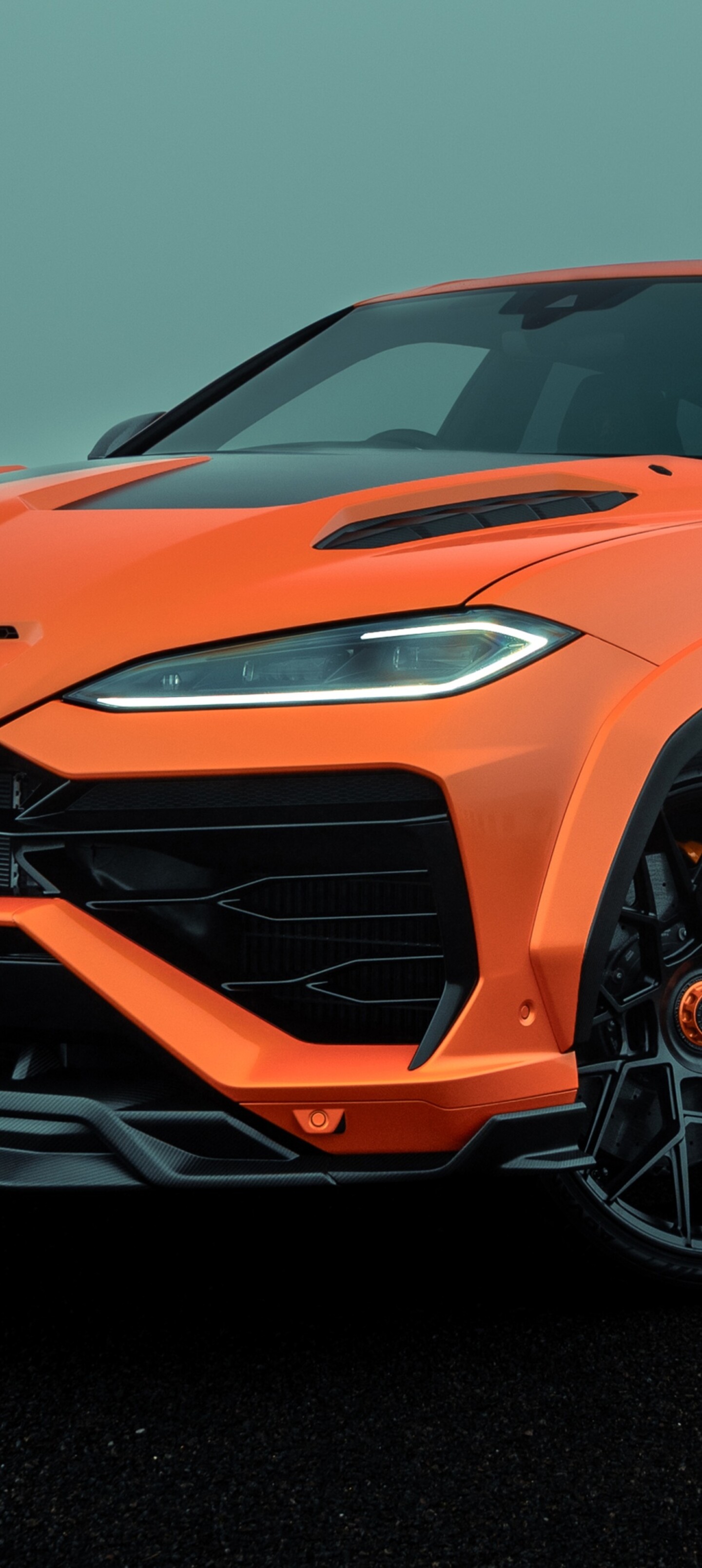 A high-resolution photograph of a Lamborghini Urus SE parked on a city street with skyscrapers in the background.
