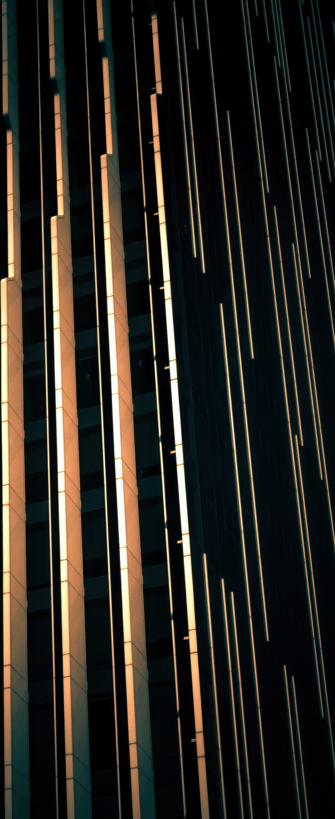 A dark, modern glass building in Abu Dhabi showcasing contemporary architectural design with a moody, dark aesthetic.