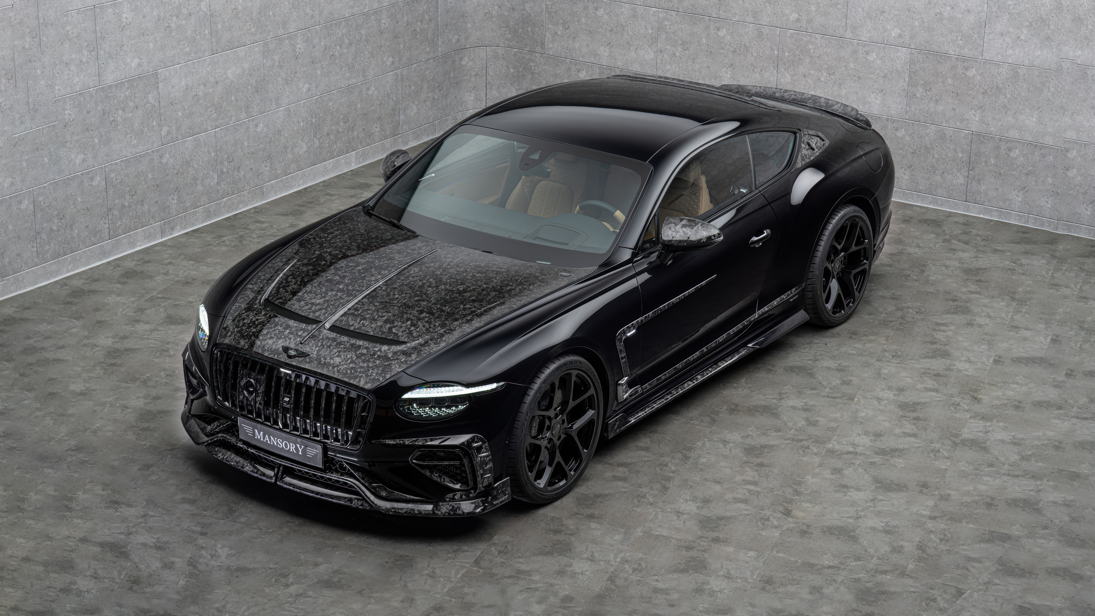 A sleek, black 2025 Mansory Bentley Continental GT Speed with custom widebody aerodynamic parts.