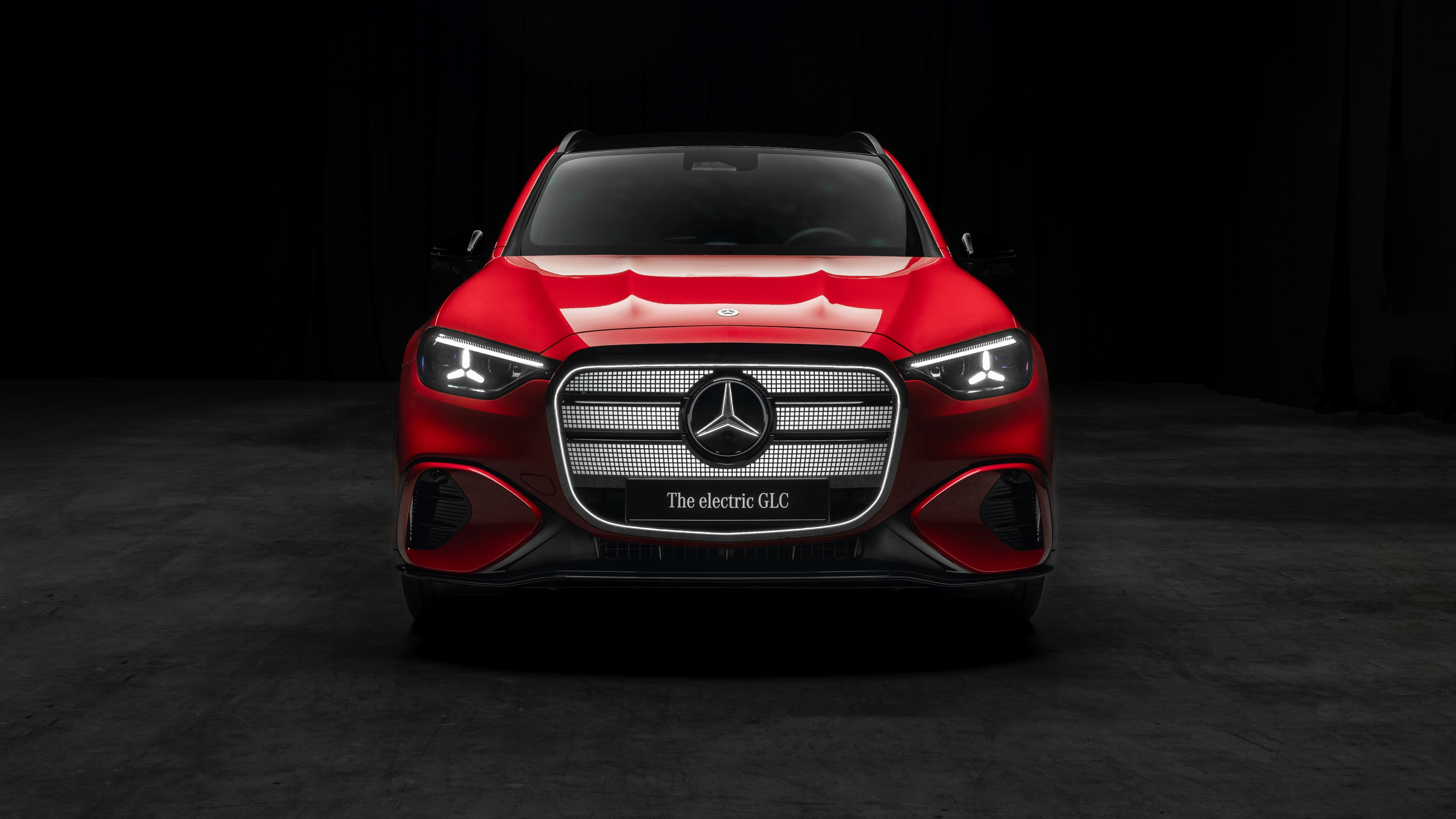A red 2026 Mercedes-Benz GLC 400 electric crossover against a dark, cinematic background.