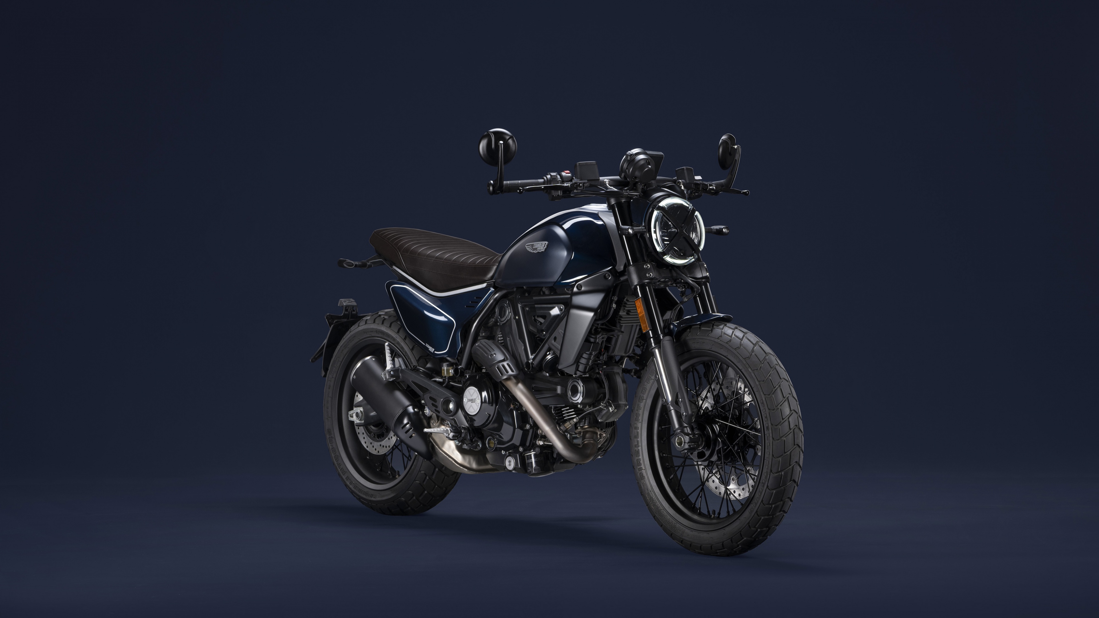 A high-detail shot of a black 2023 Ducati Scrambler Nightshift cafe racer motorcycle.