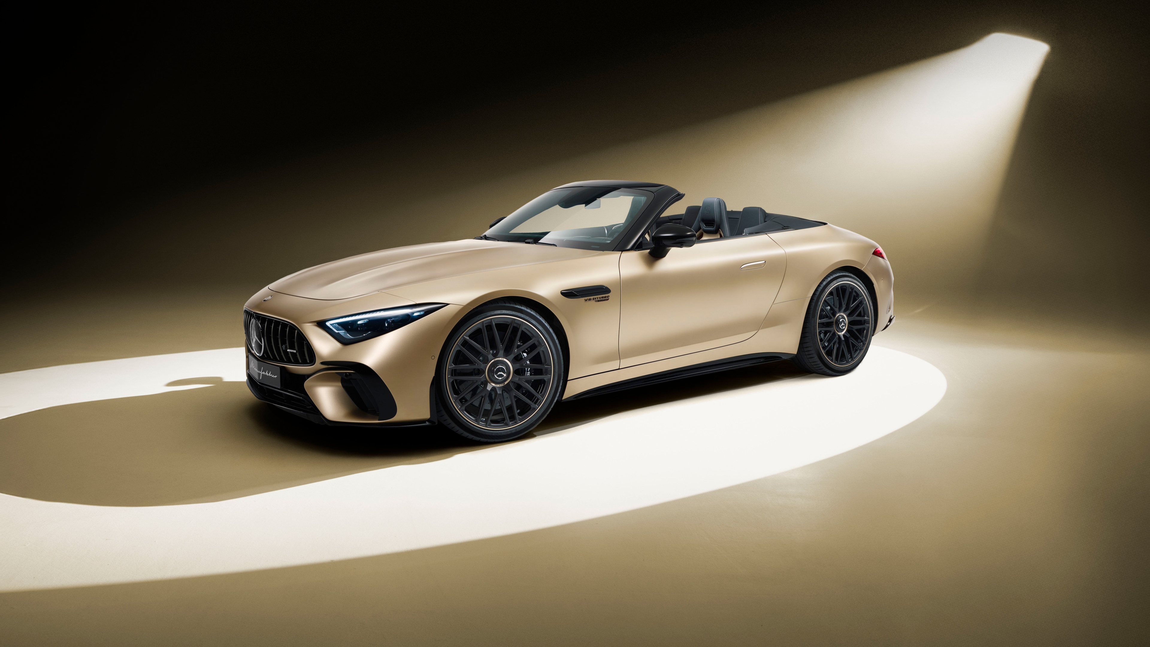 A luxurious 2025 Mercedes-AMG SL 63 4MATIC in a striking golden finish, highlighting its premium design and aerodynamic features.