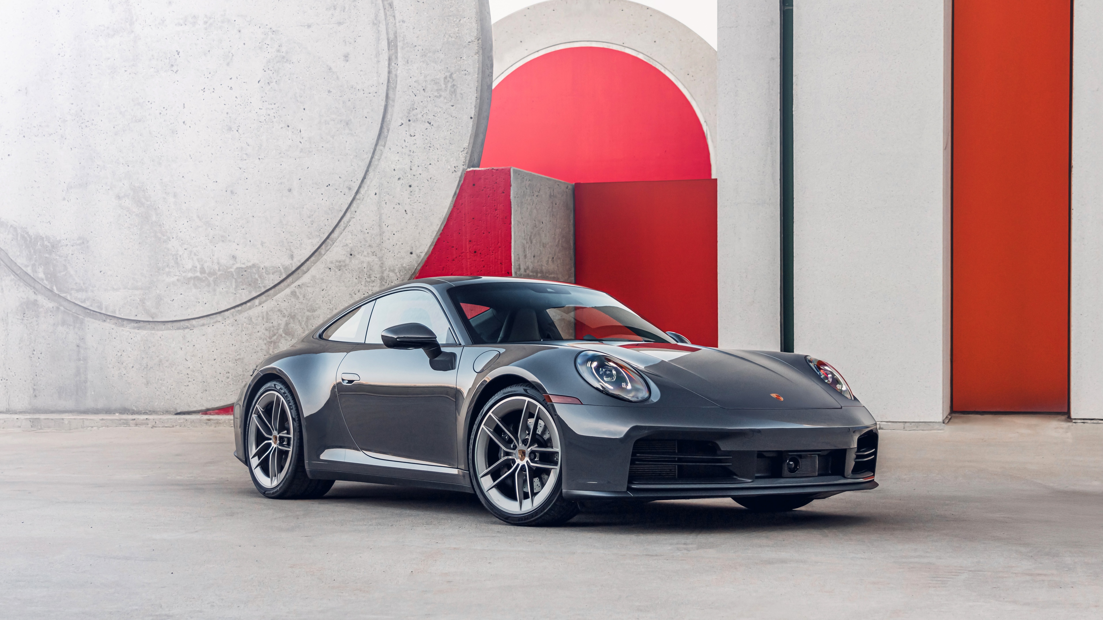 A high-detail, cinematic view of a 2025 Porsche 911 Carrera showcasing its sleek design and metallic finish.