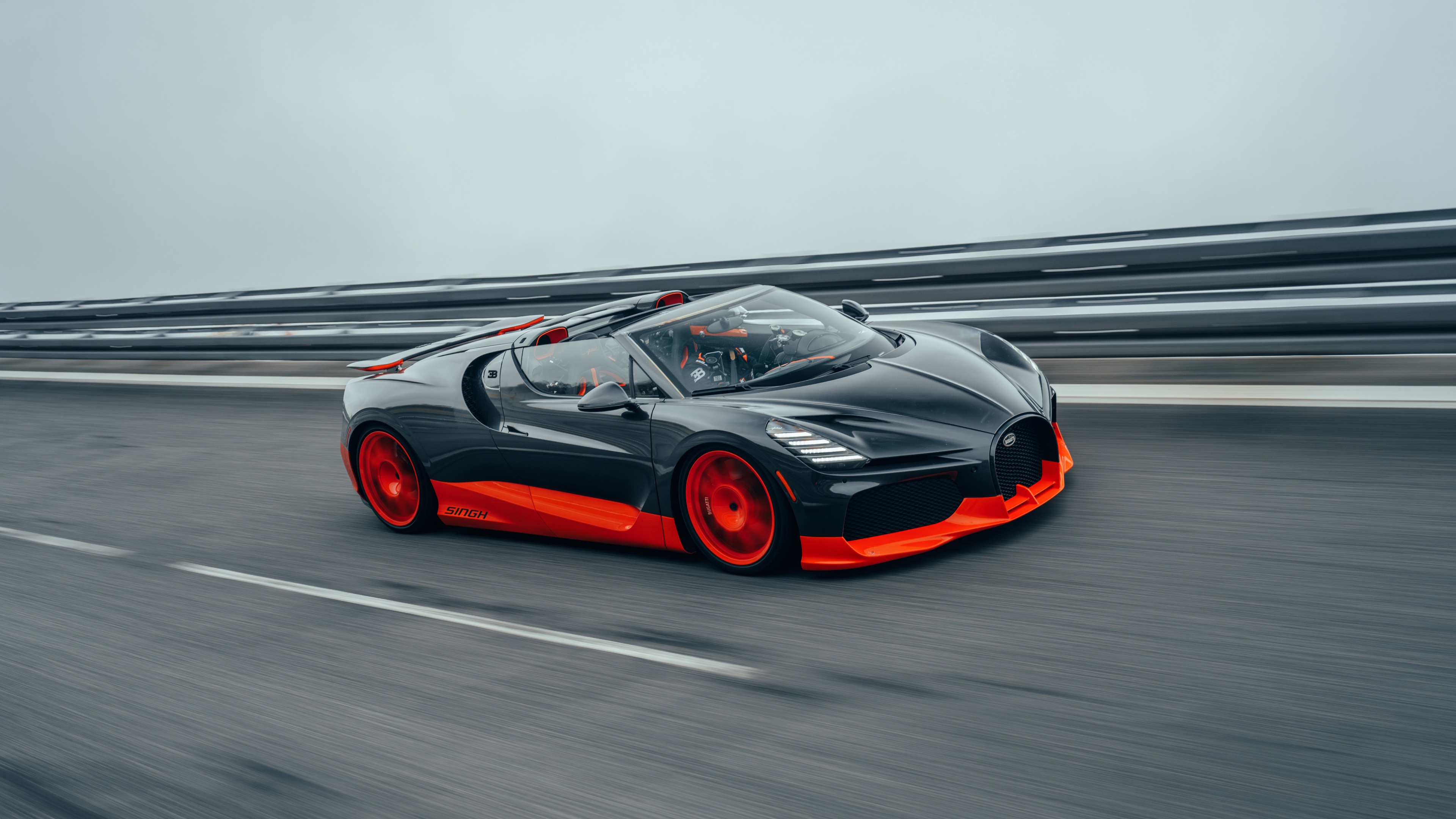 A sleek and aerodynamic Bugatti W16 Mistral 2024 hypercar captured in a high-resolution racing setting.