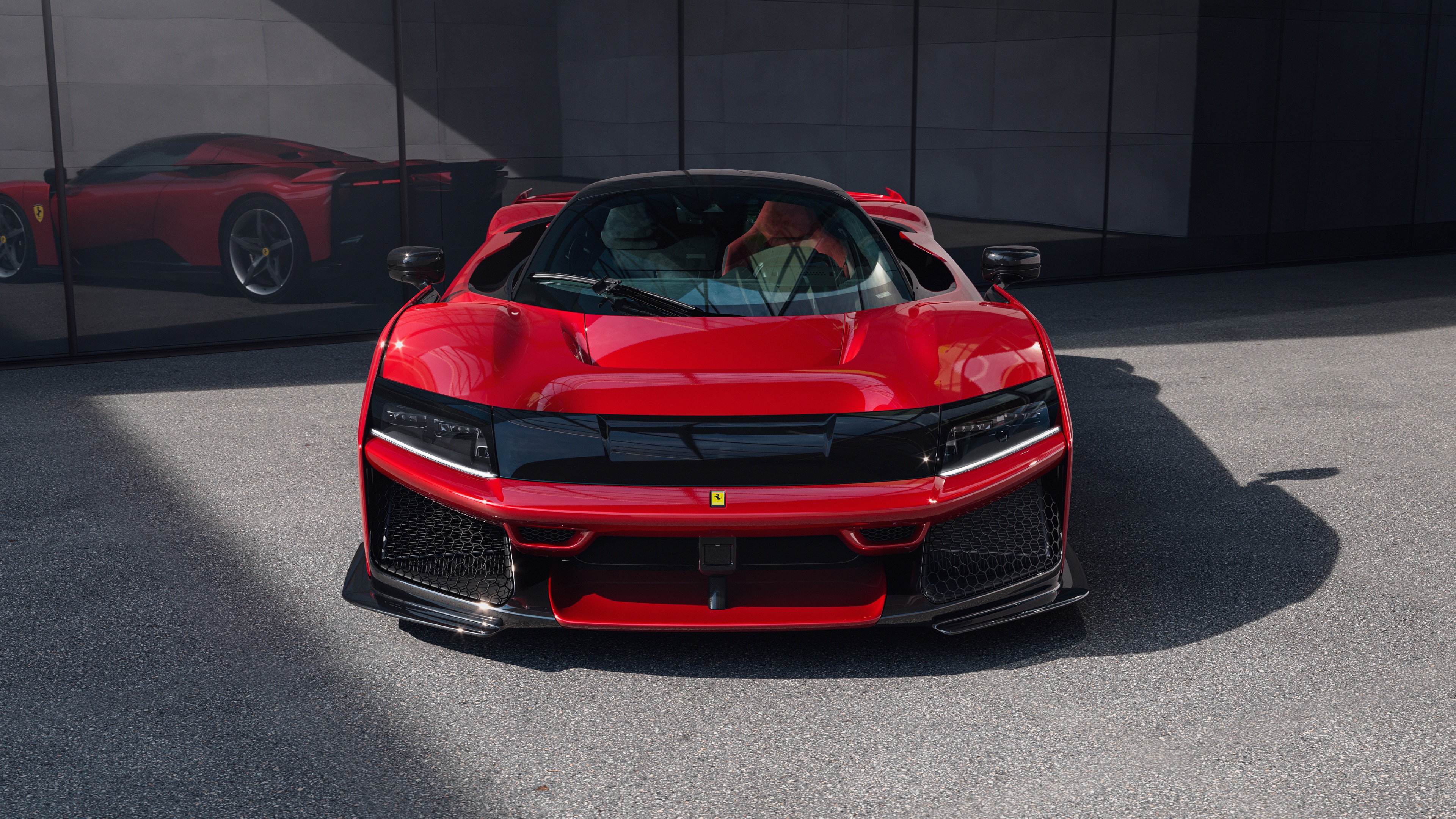 A high-resolution, close-up shot of a sleek red Ferrari F80 hypercar highlighting its futuristic aerodynamic curves and premium finish.