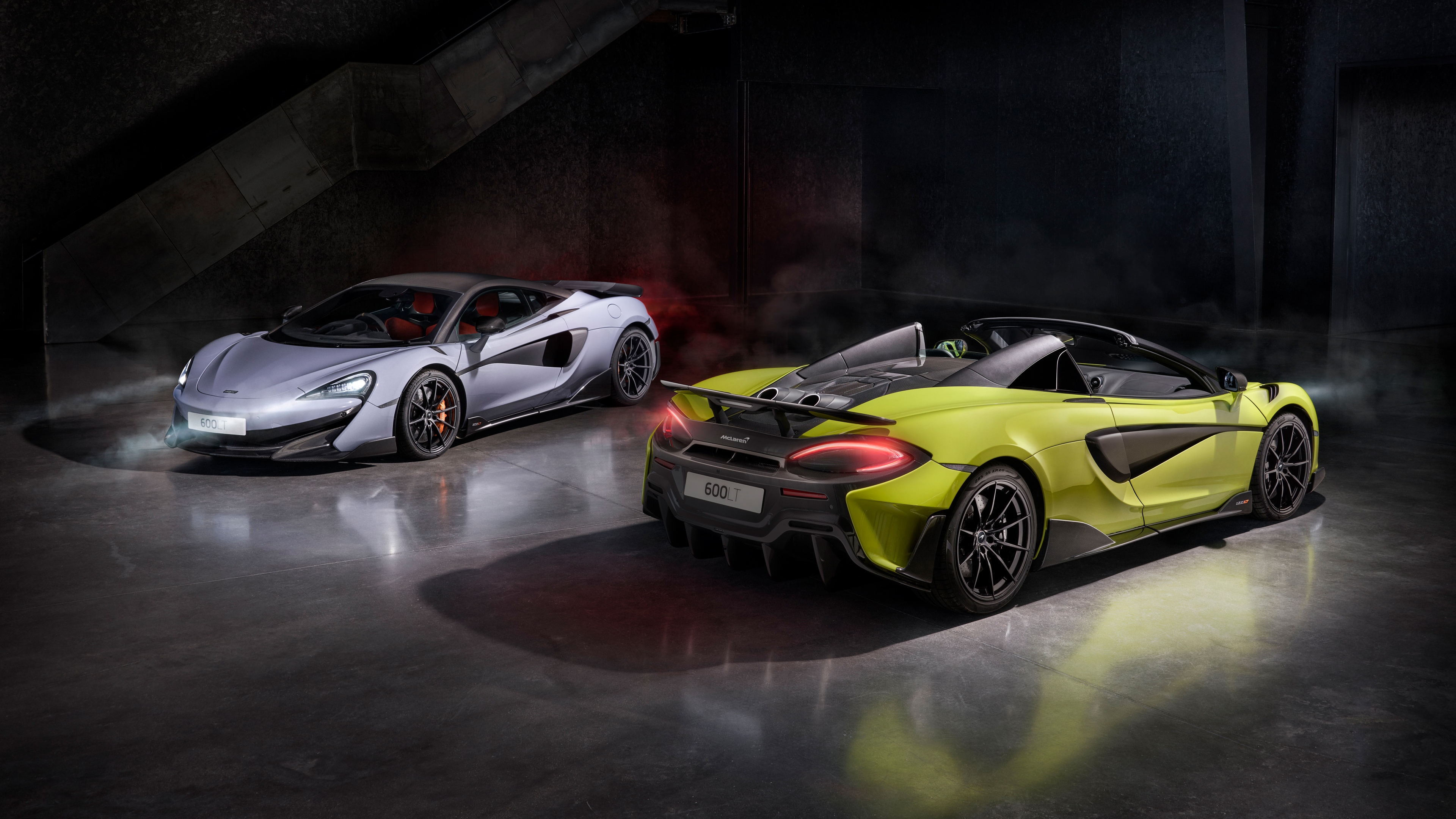 A detailed, high-definition view of a McLaren 600LT Spider supercar showcasing its aerodynamic design and sleek metallic finish.