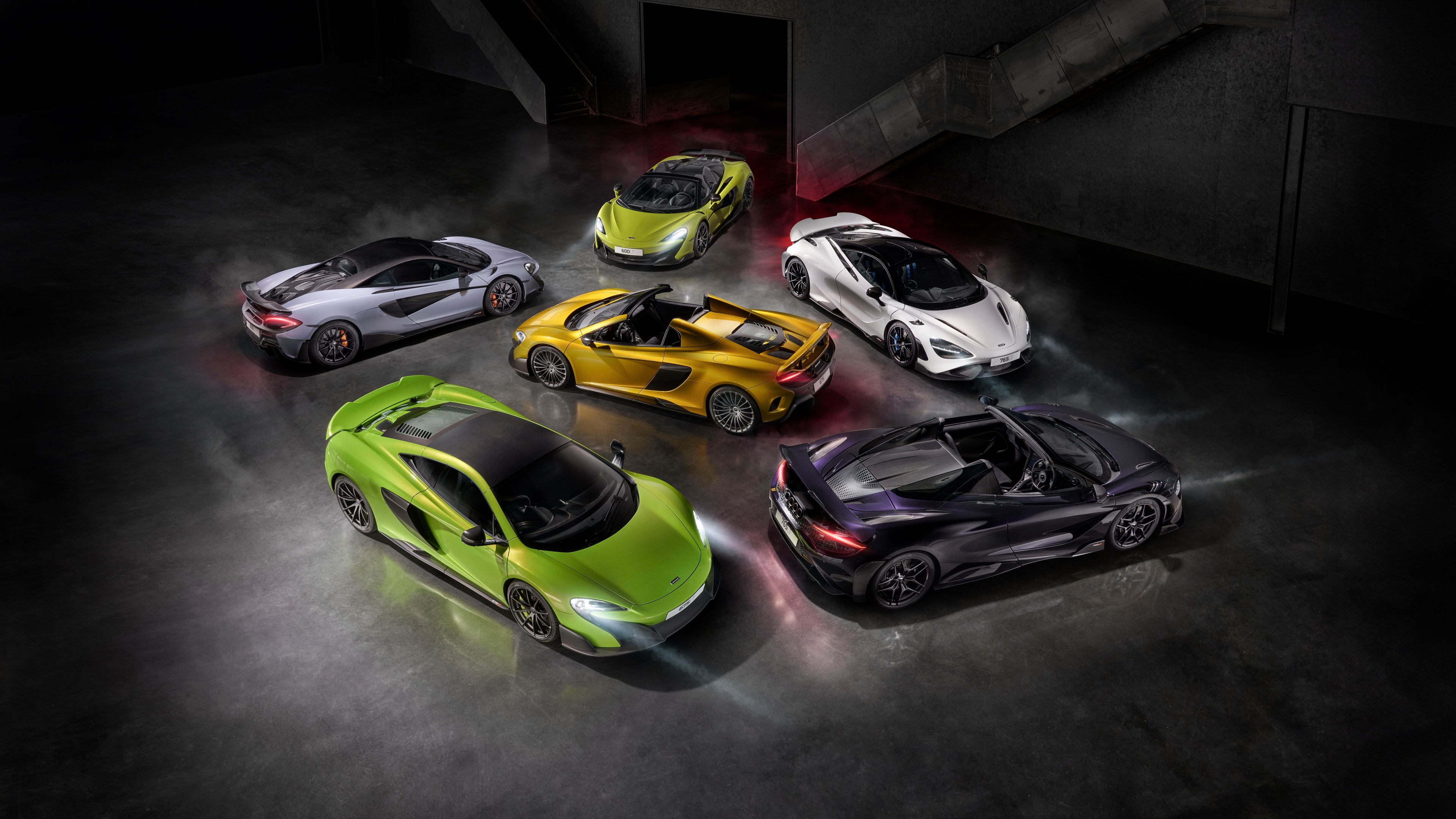 A high-resolution lineup of McLaren 600LT, 675LT, and 765LT supercars showcasing aerodynamic design and luxury.