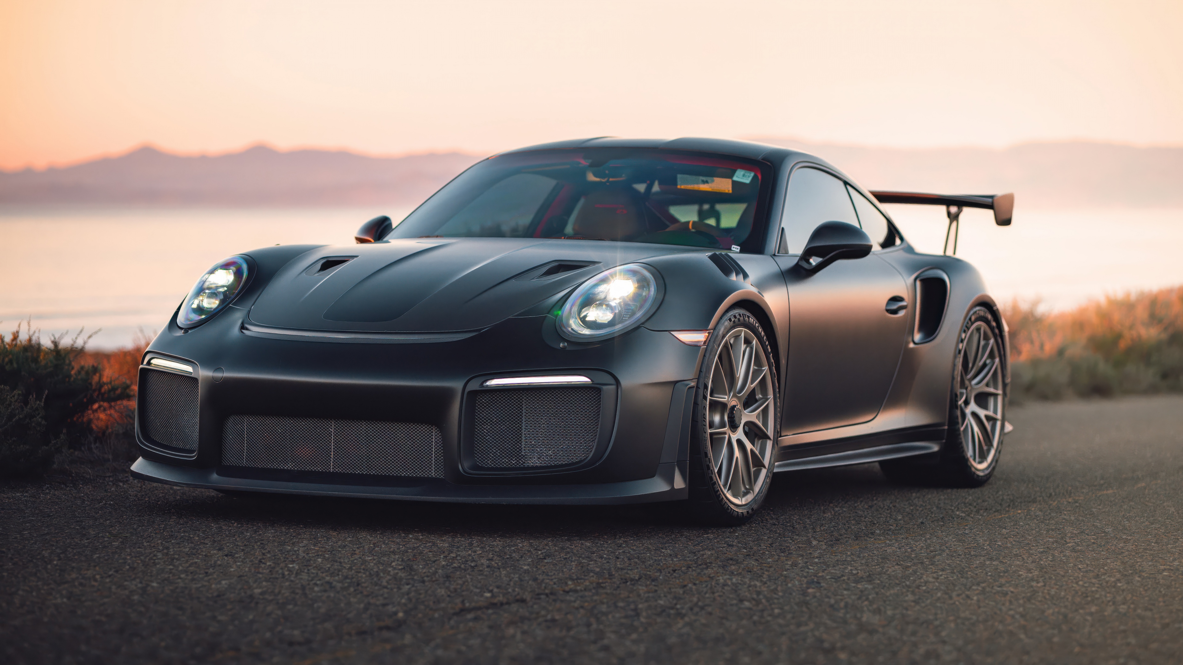 A detailed view of a Porsche 911 GT2 RS featuring the Weissach package, highlighting its aerodynamic carbon fiber components and high-performance design.