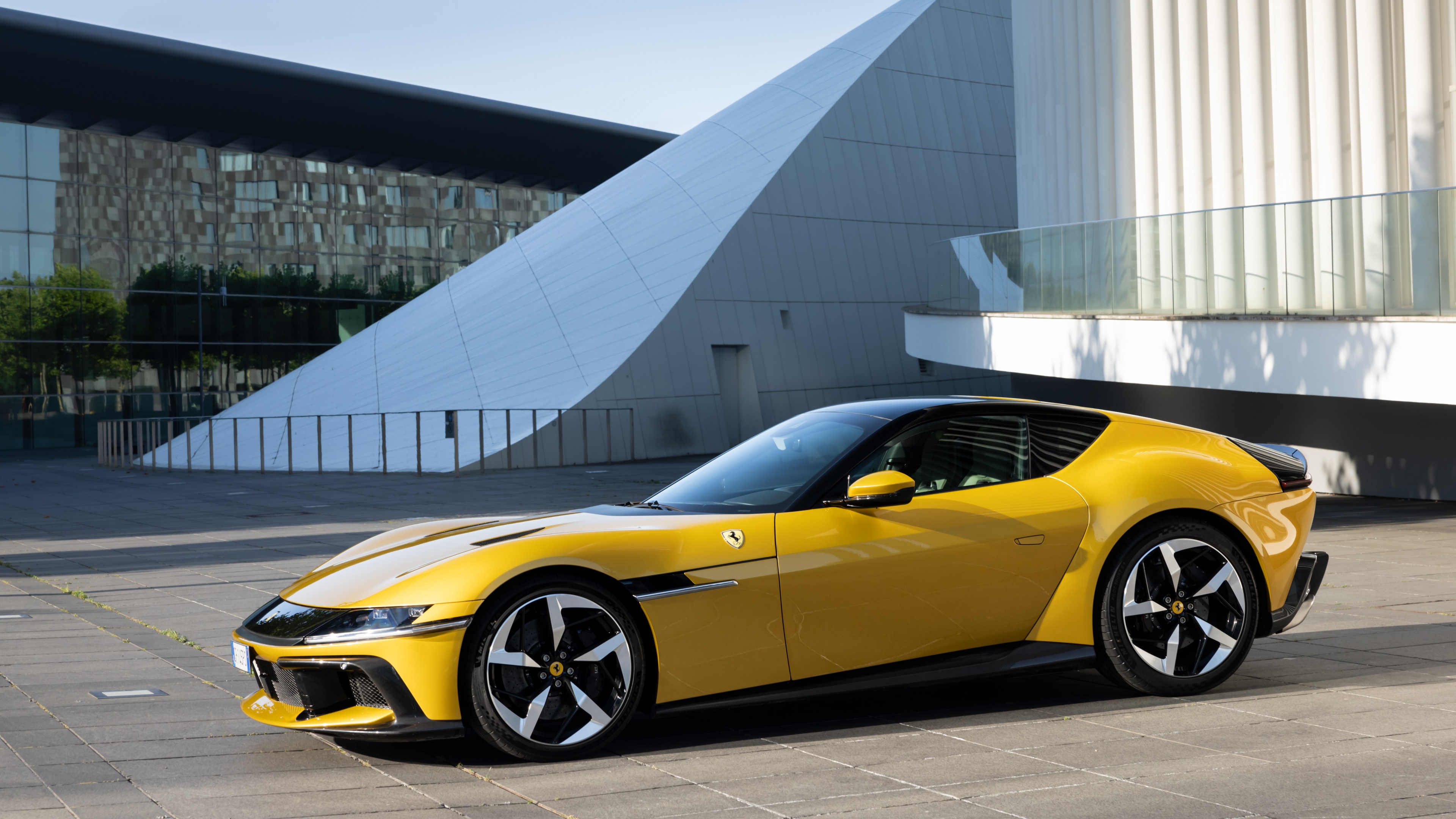 A vibrant yellow Ferrari 12Cilindri sports car parked outdoors in high detail.