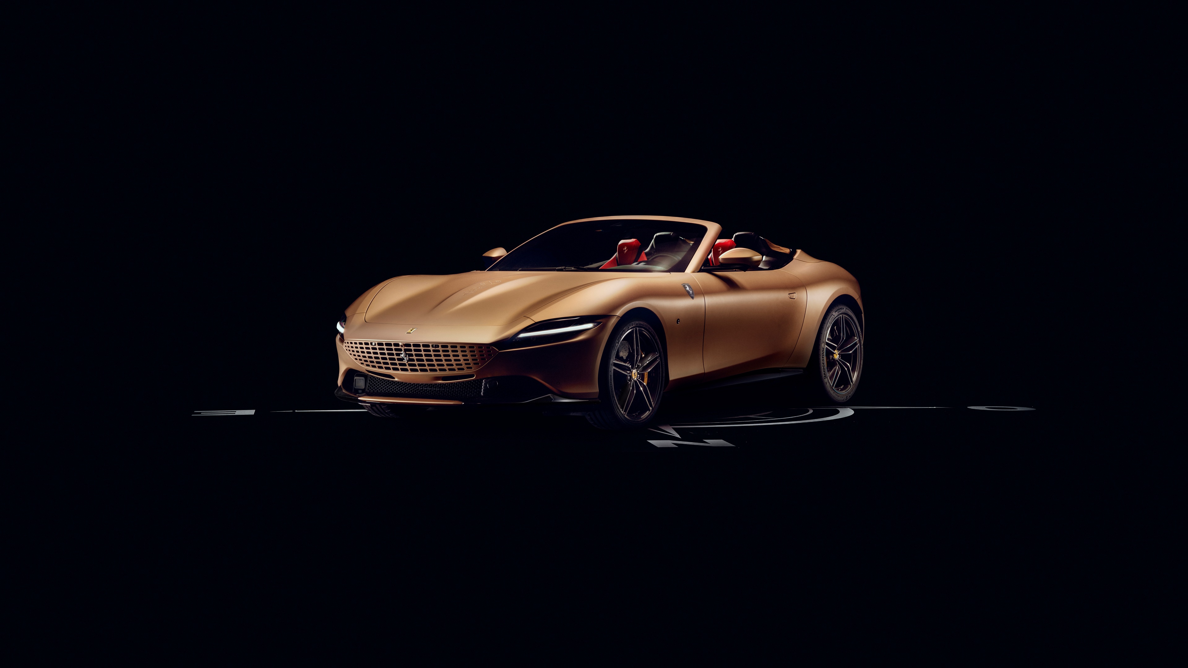 A high-resolution studio shot of a customized 2024 Ferrari Roma Spider against a solid black background.
