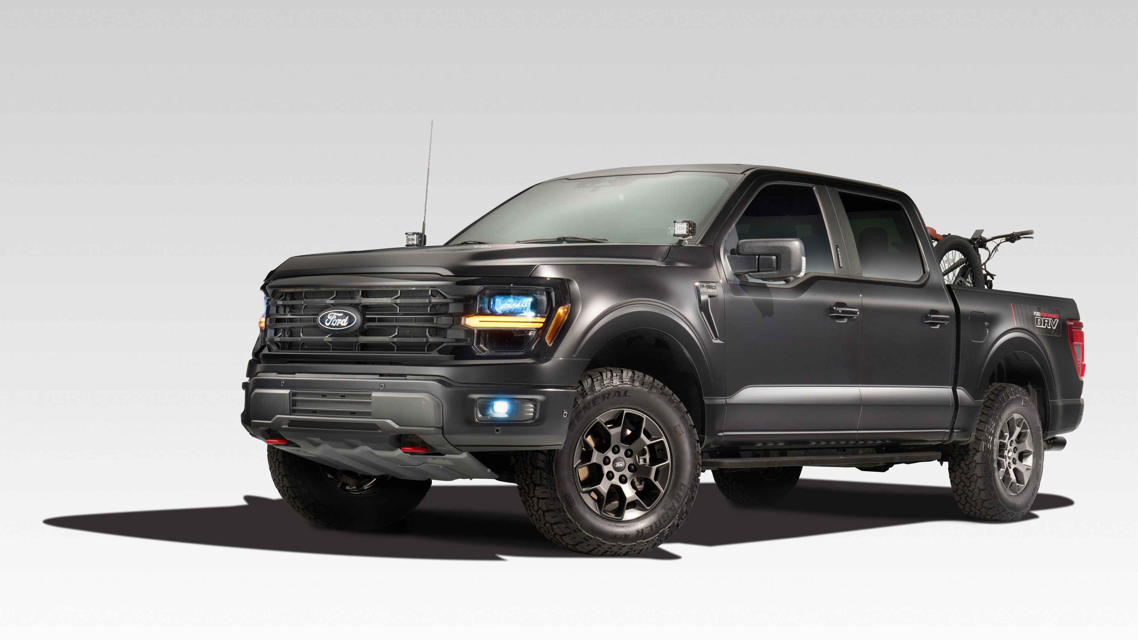 A high-resolution studio shot of a 2024 Ford F-150 pickup truck isolated on a white background.