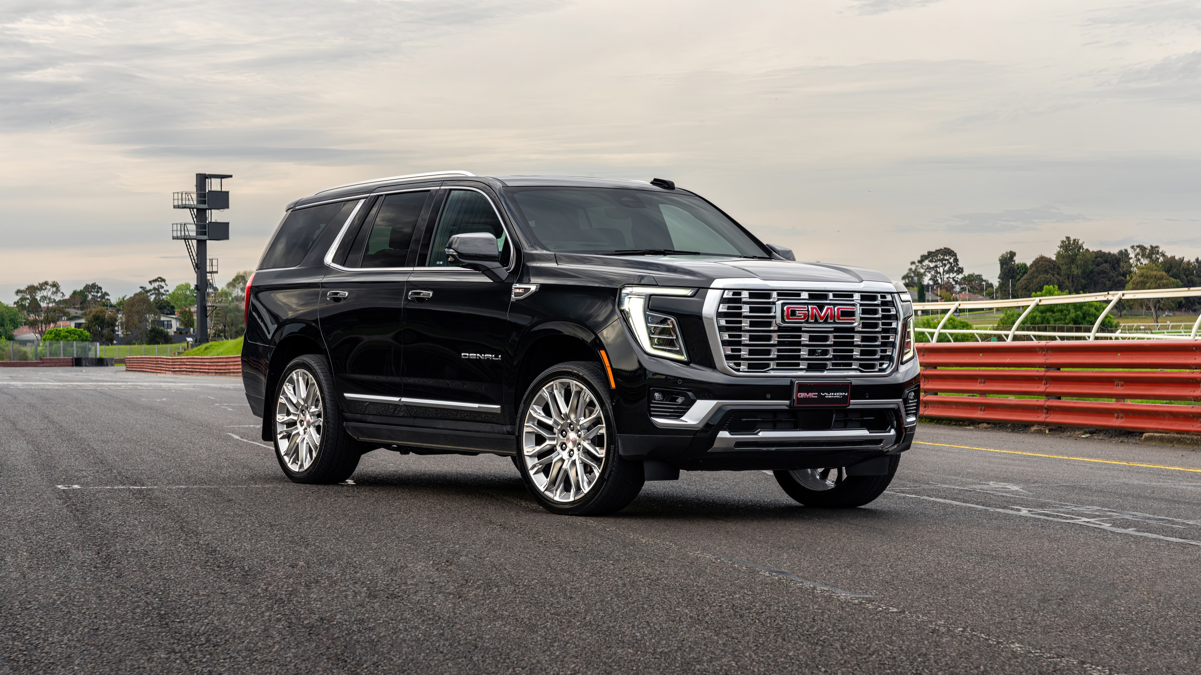 A sleek 2024 GMC Yukon Denali luxury SUV featuring premium chrome accents and a modern, imposing design.