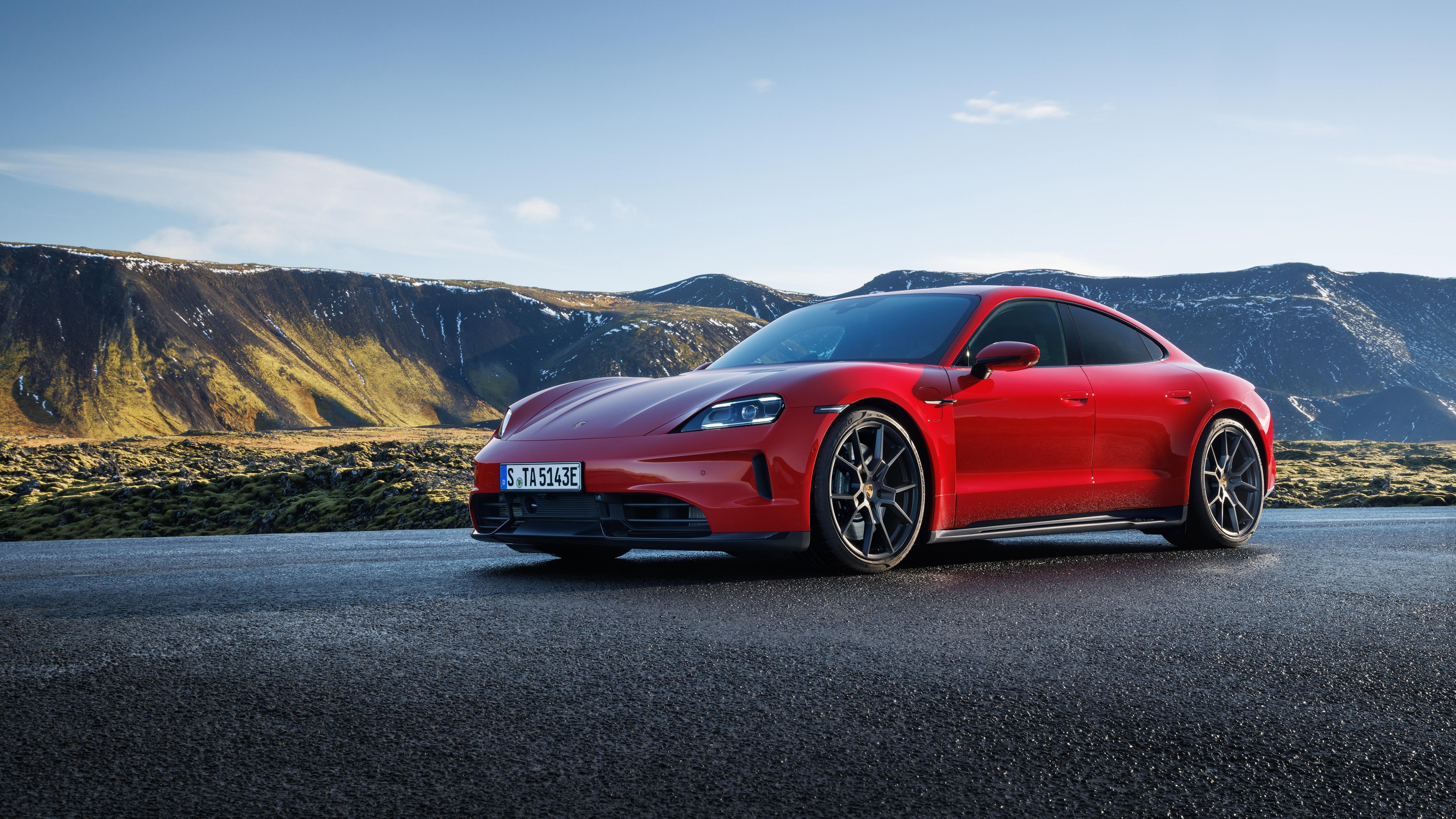 A sleek, bright red 2024 Porsche Taycan GTS electric sports car featuring a modern aerodynamic design.