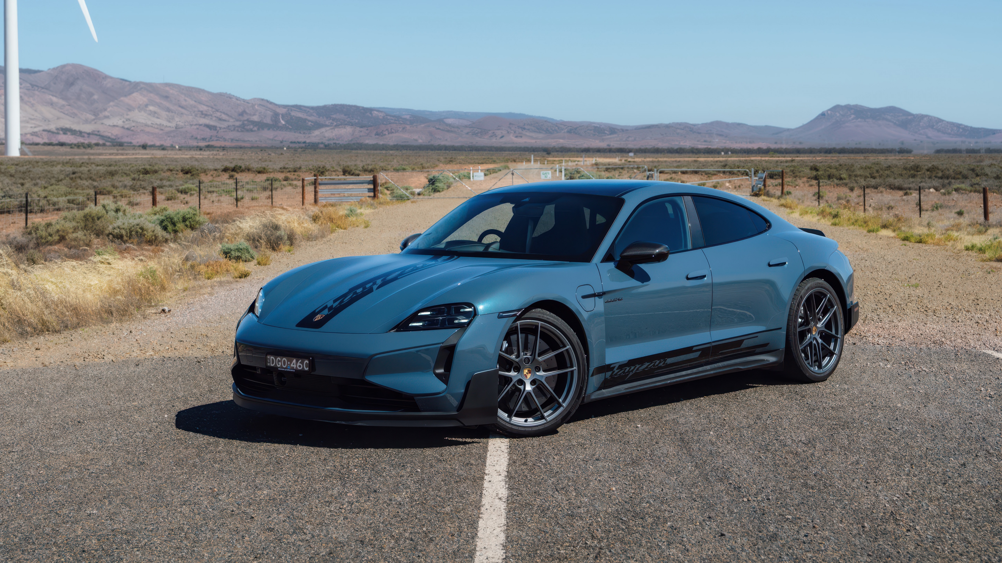 A close-up, high-detail view of the 2024 Porsche Taycan Turbo GT electric luxury sports car.