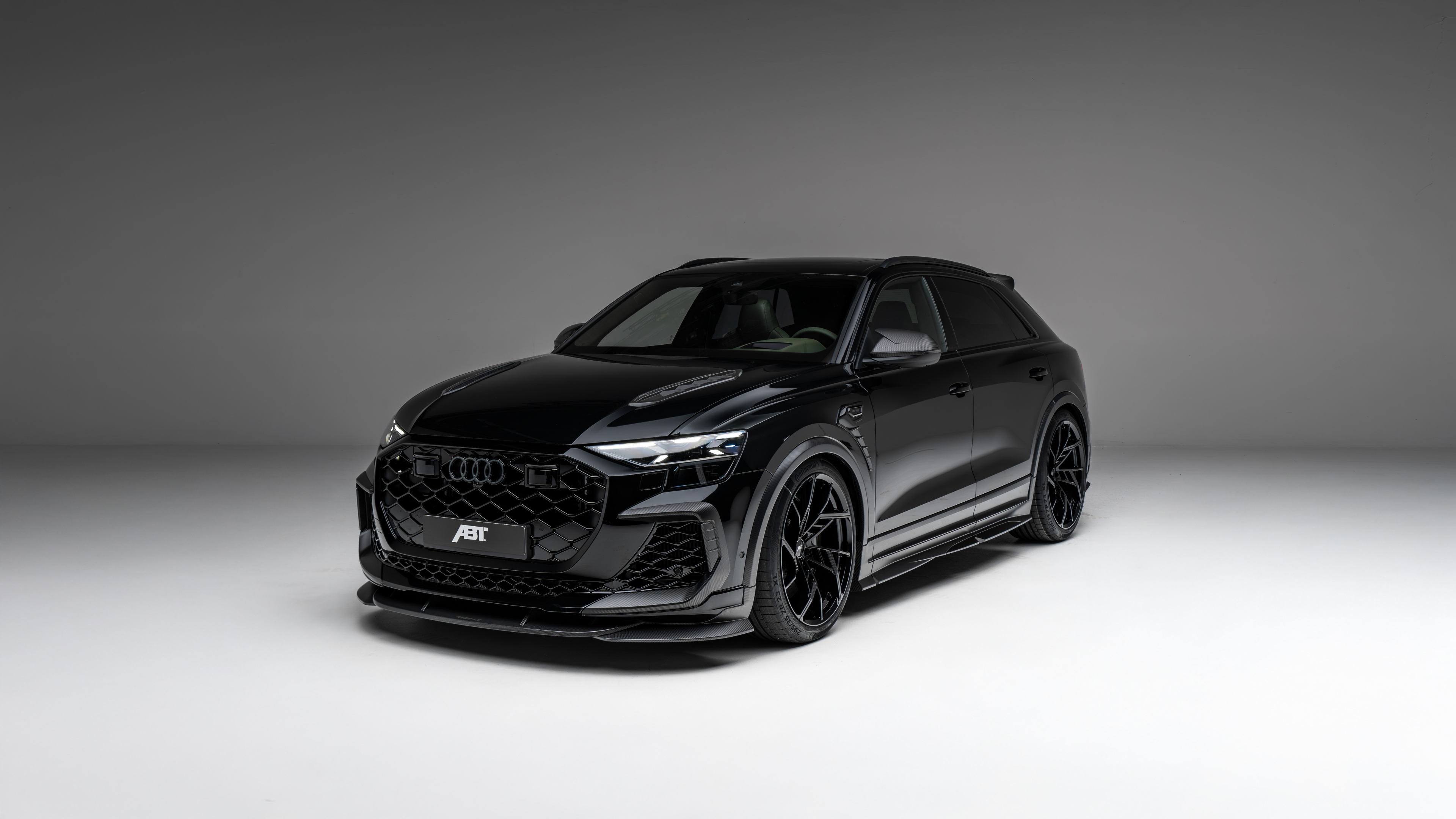 A sleek, black 2025 ABT Audi RS Q8 Legacy Edition luxury SUV parked in a premium setting.