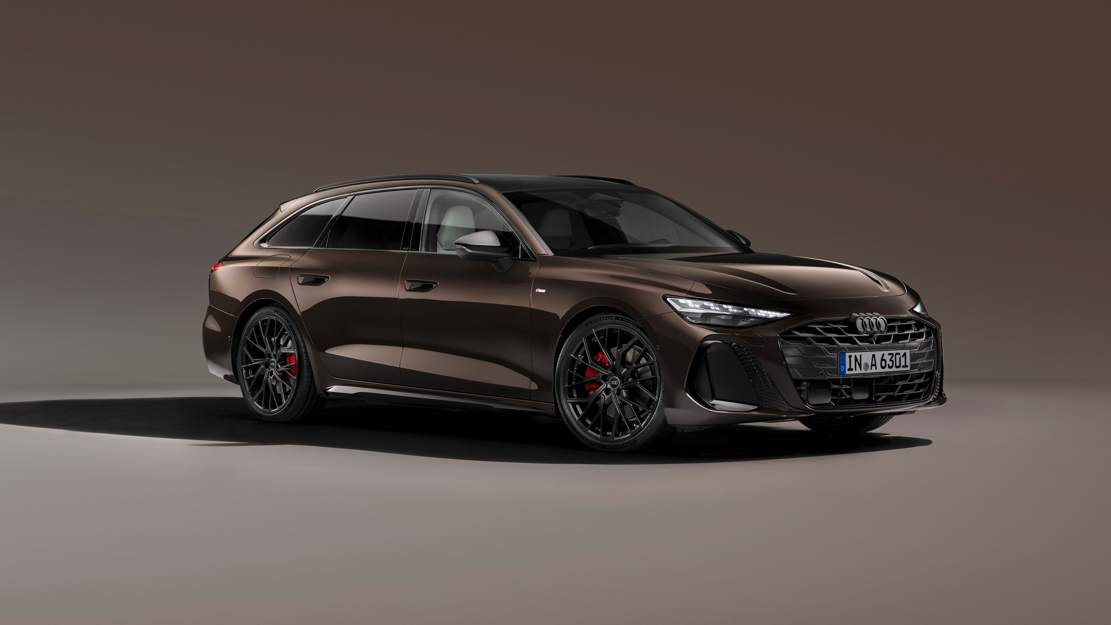 A high-resolution studio shot of the 2025 Audi A6 Avant station wagon against a solid grey background.