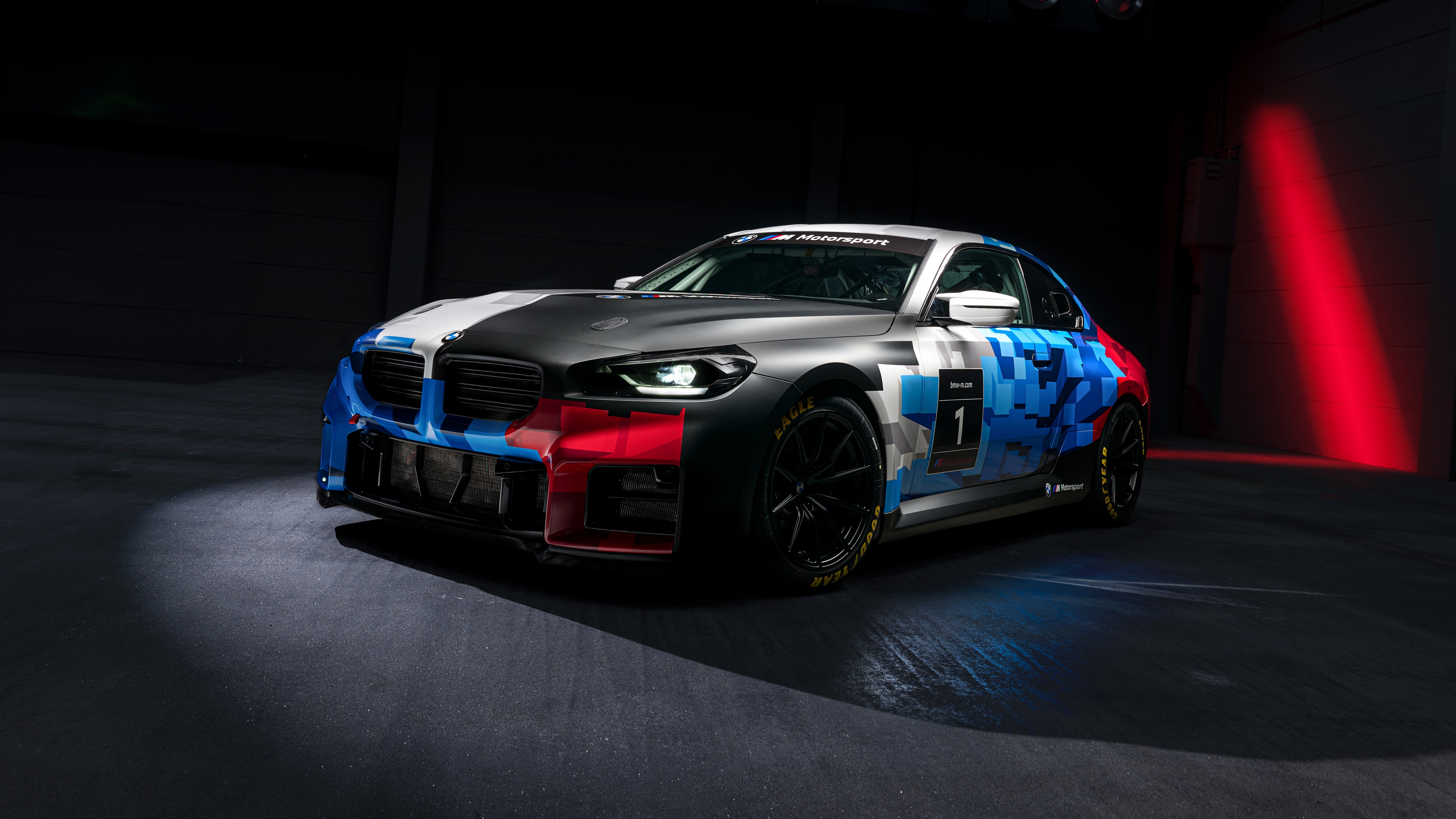 High-detail 5K shot of a 2025 BMW M2 in a dark, moody aesthetic featuring sleek shadows and metallic textures.