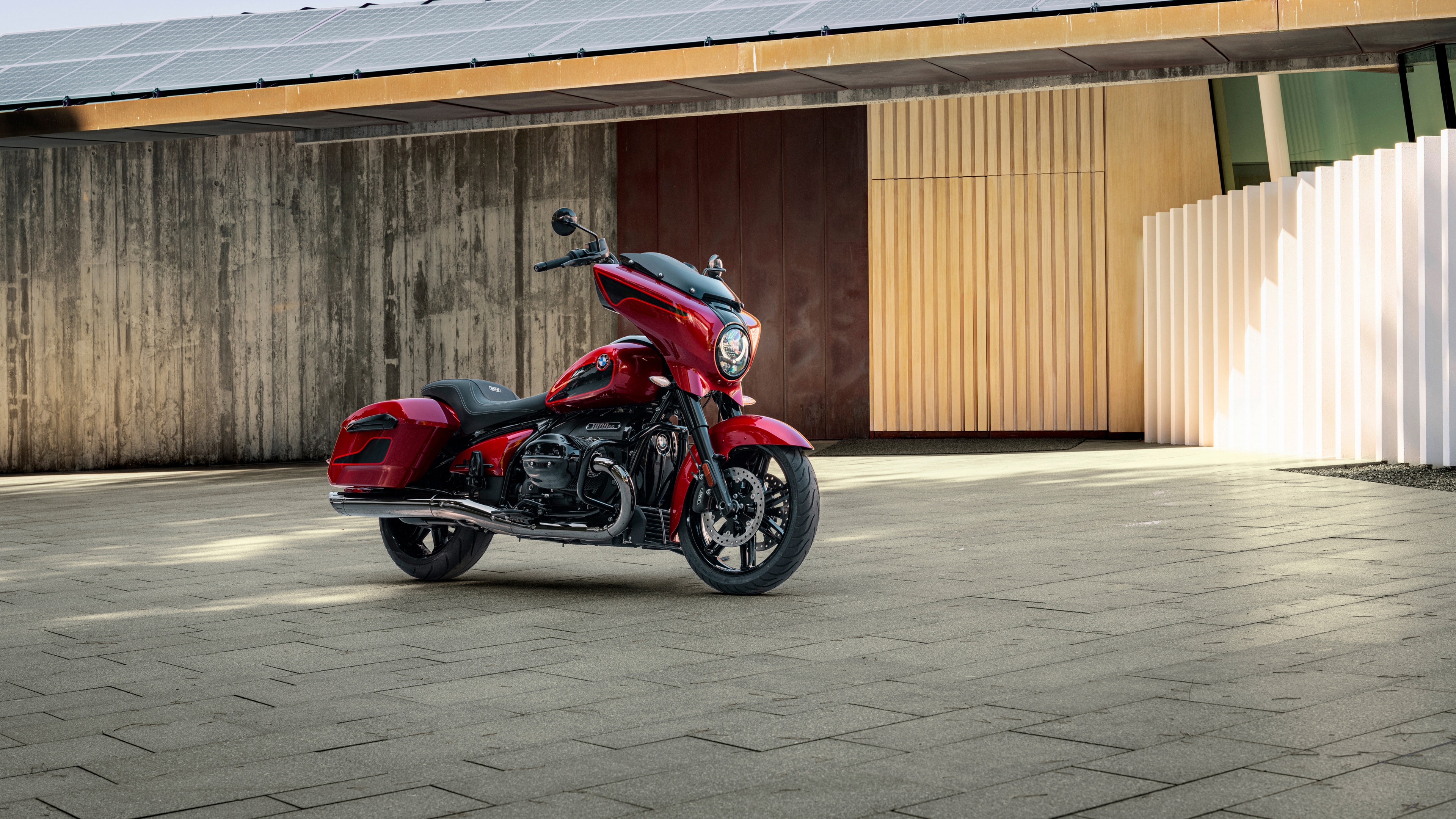 A close-up shot of a red 2025 BMW R 18 touring motorcycle showcasing its metallic finish and engineering detail.