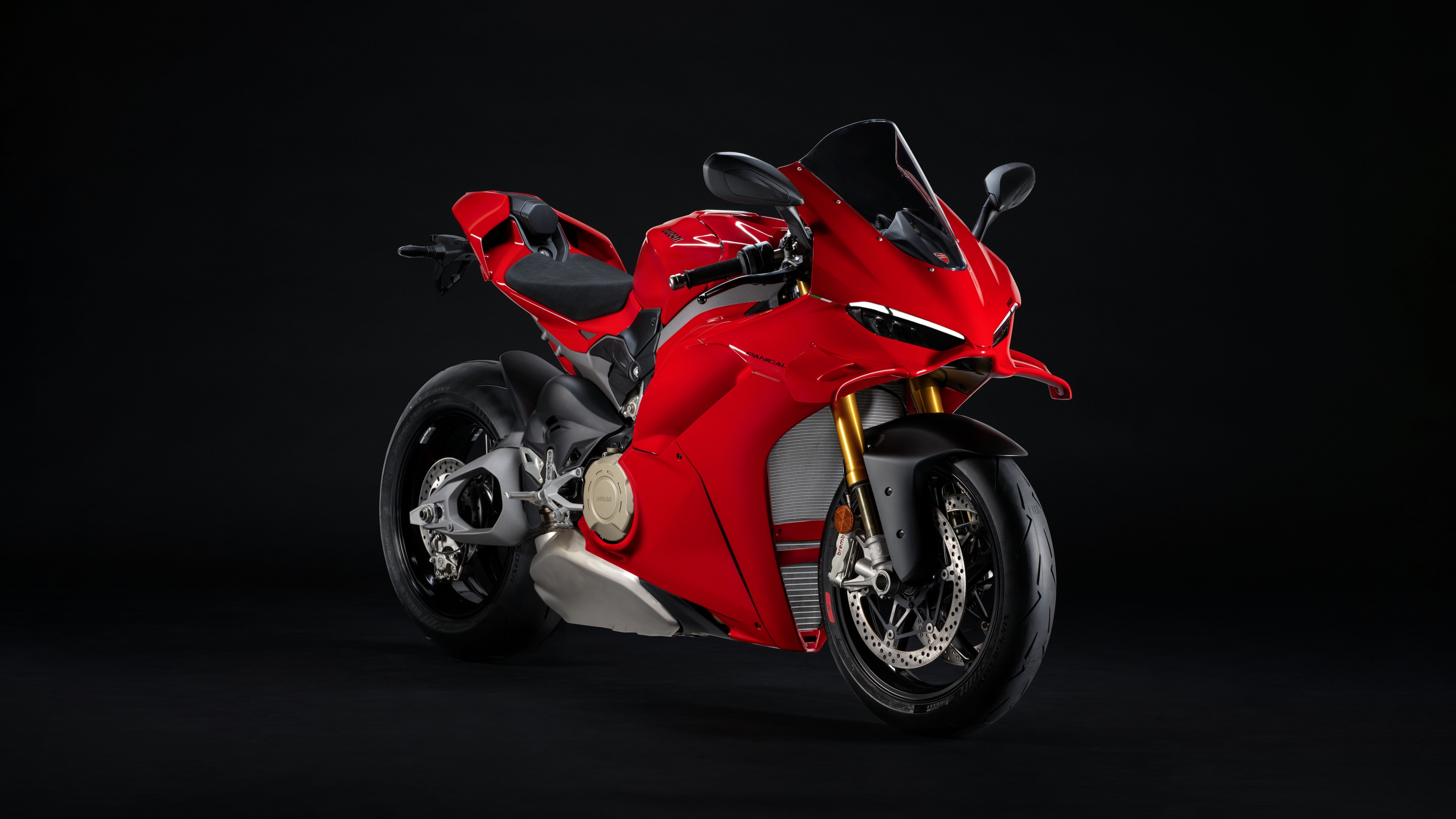 Close-up shot of a 2025 Ducati Panigale V4 S sport motorcycle on a dark, minimalist background.
