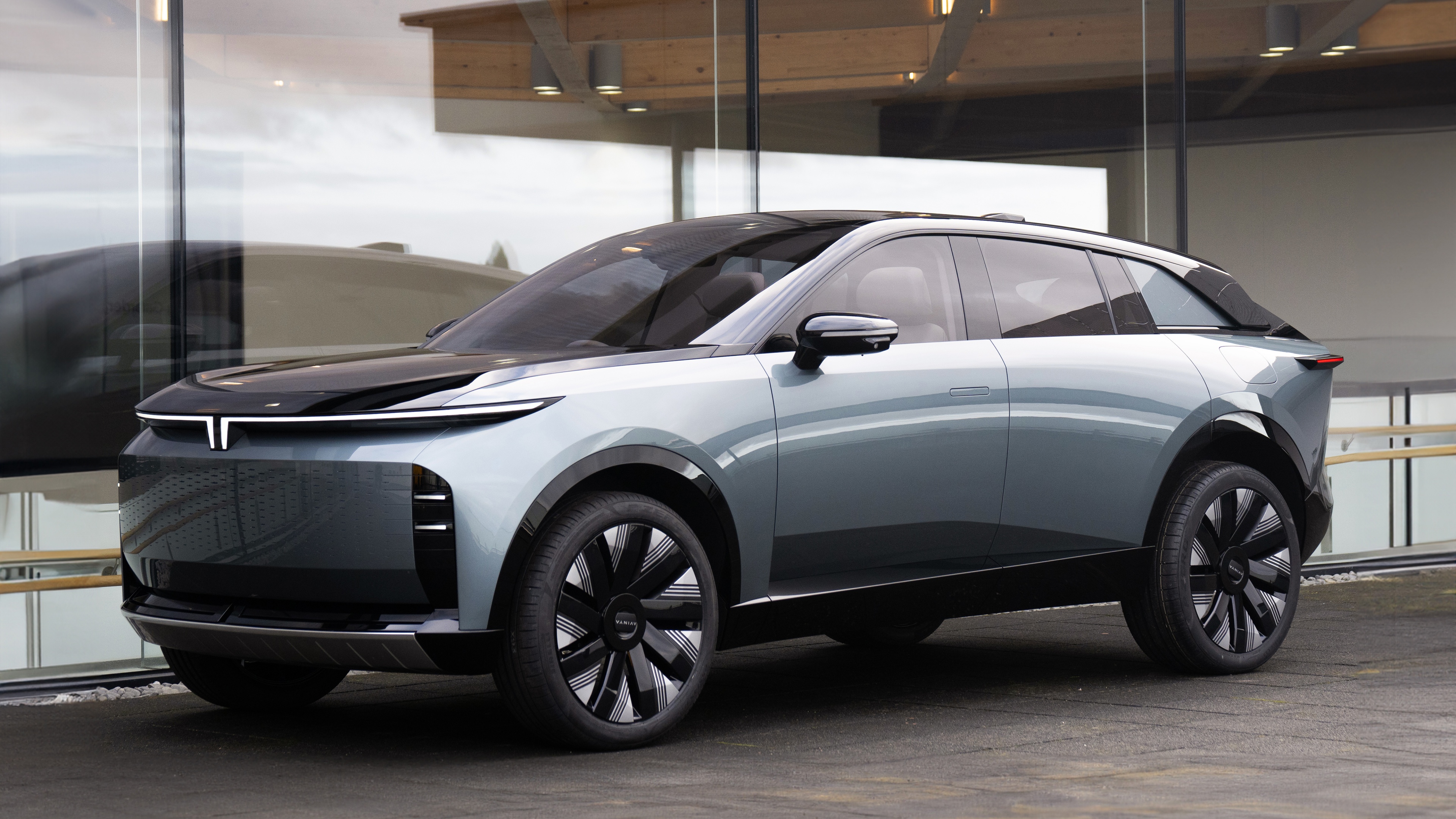 A sleek and aerodynamic 2025 electric crossover concept car with a modern metallic finish.