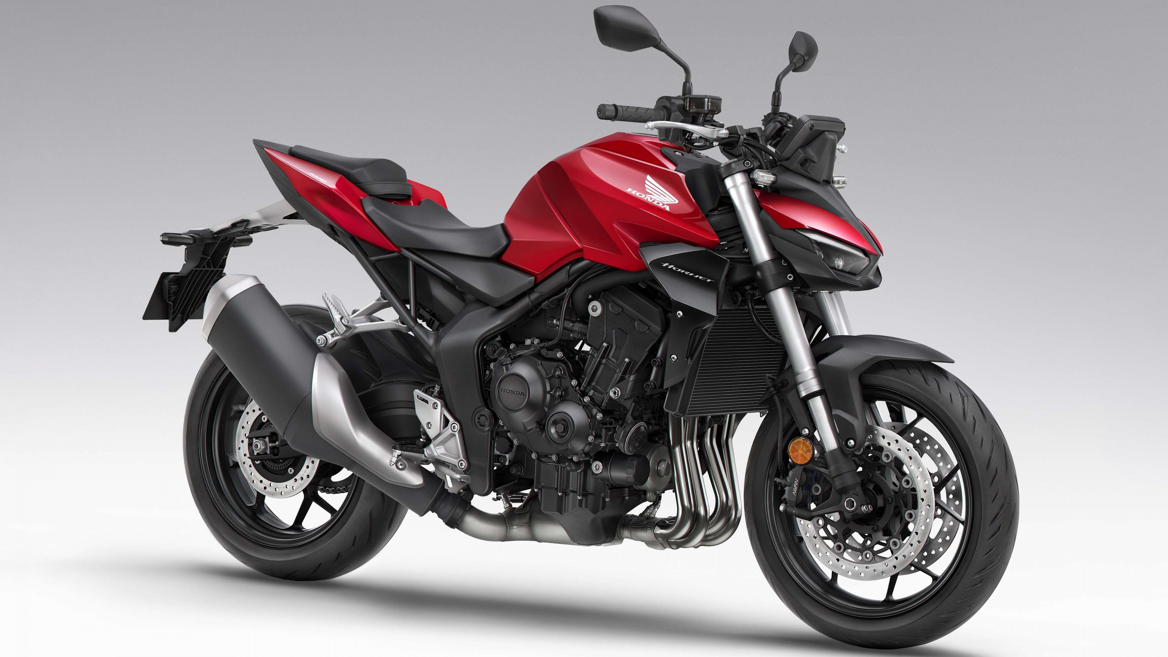 A detailed, high-resolution close-up of the 2025 Honda CB1000 Hornet sports motorcycle, highlighting its aggressive naked bike styling.