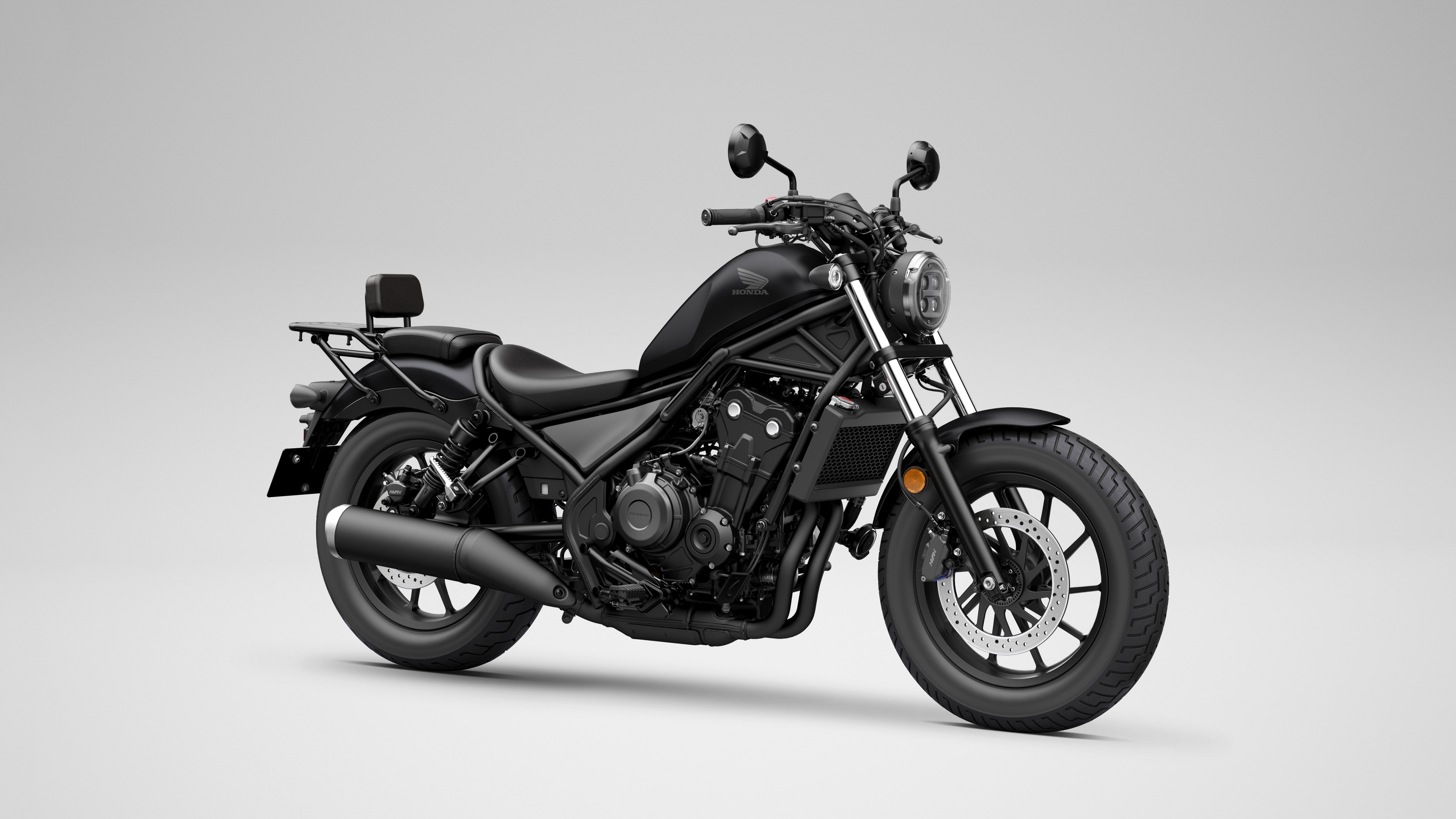 A detailed, high-resolution close-up of the 2025 Honda CMX500 Rebel cruiser motorcycle featuring a modern design and metallic accents.