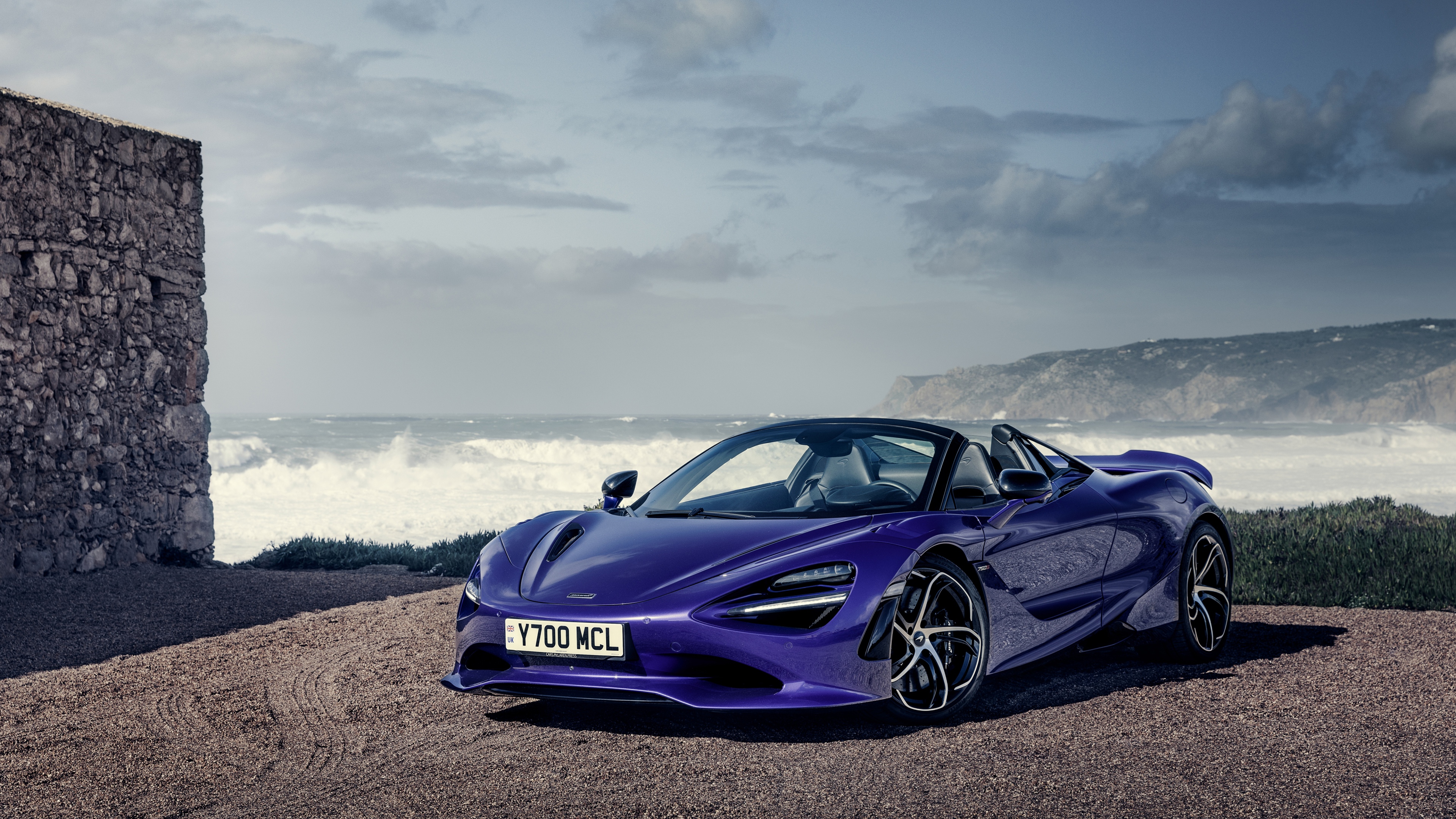 A high-detail view of a 2025 McLaren 750S Spider convertible sports car.