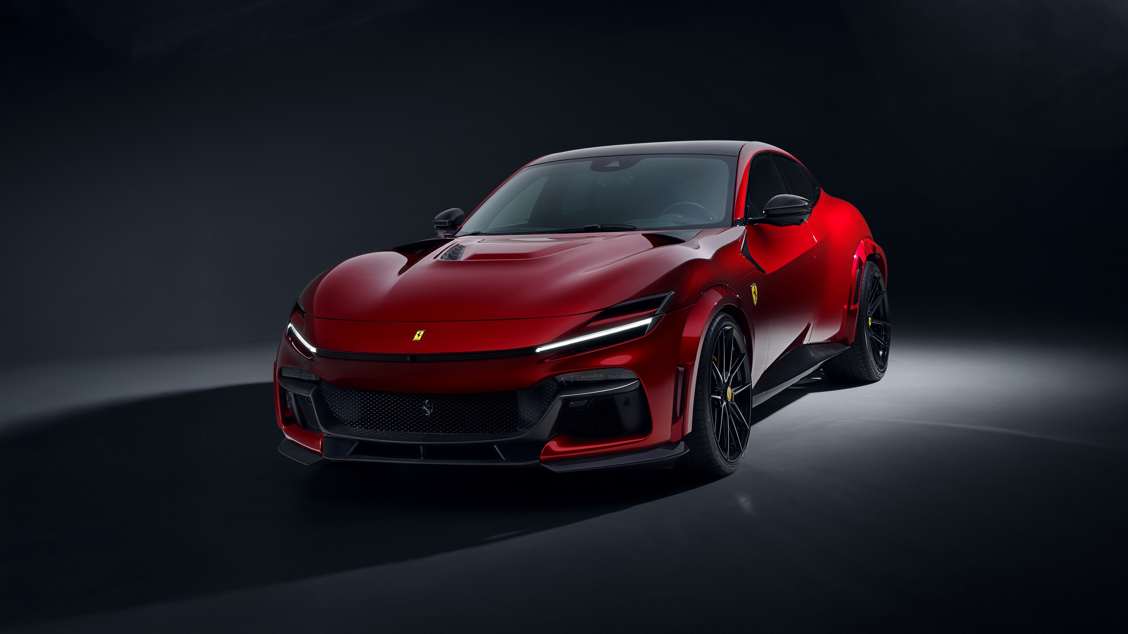 A high-resolution close-up of a red 2025 Novitec Ferrari Purosangue against a dark, moody studio background.