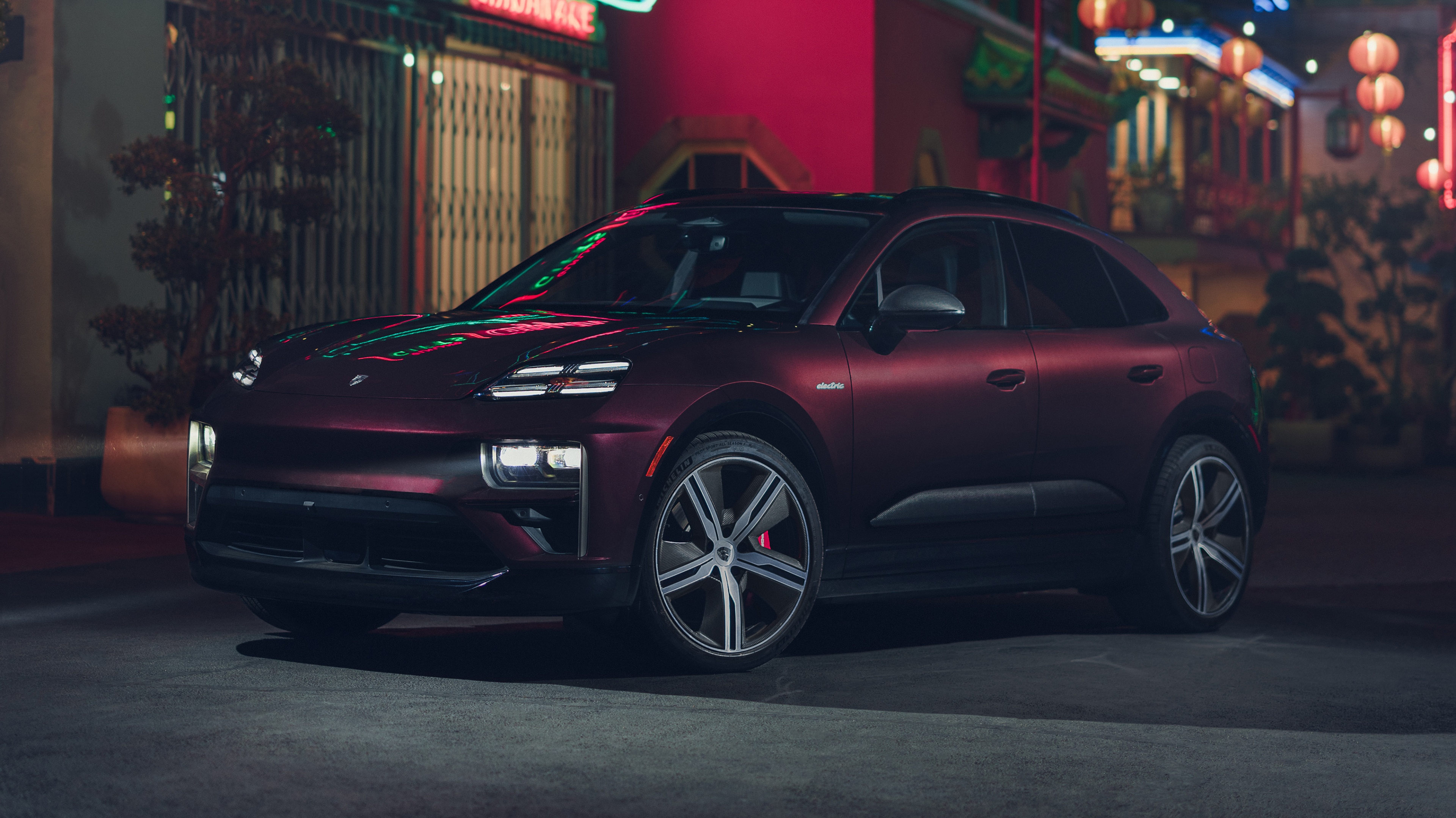 A sleek 2025 Porsche Macan Turbo electric SUV featuring modern aerodynamic styling and a futuristic design.