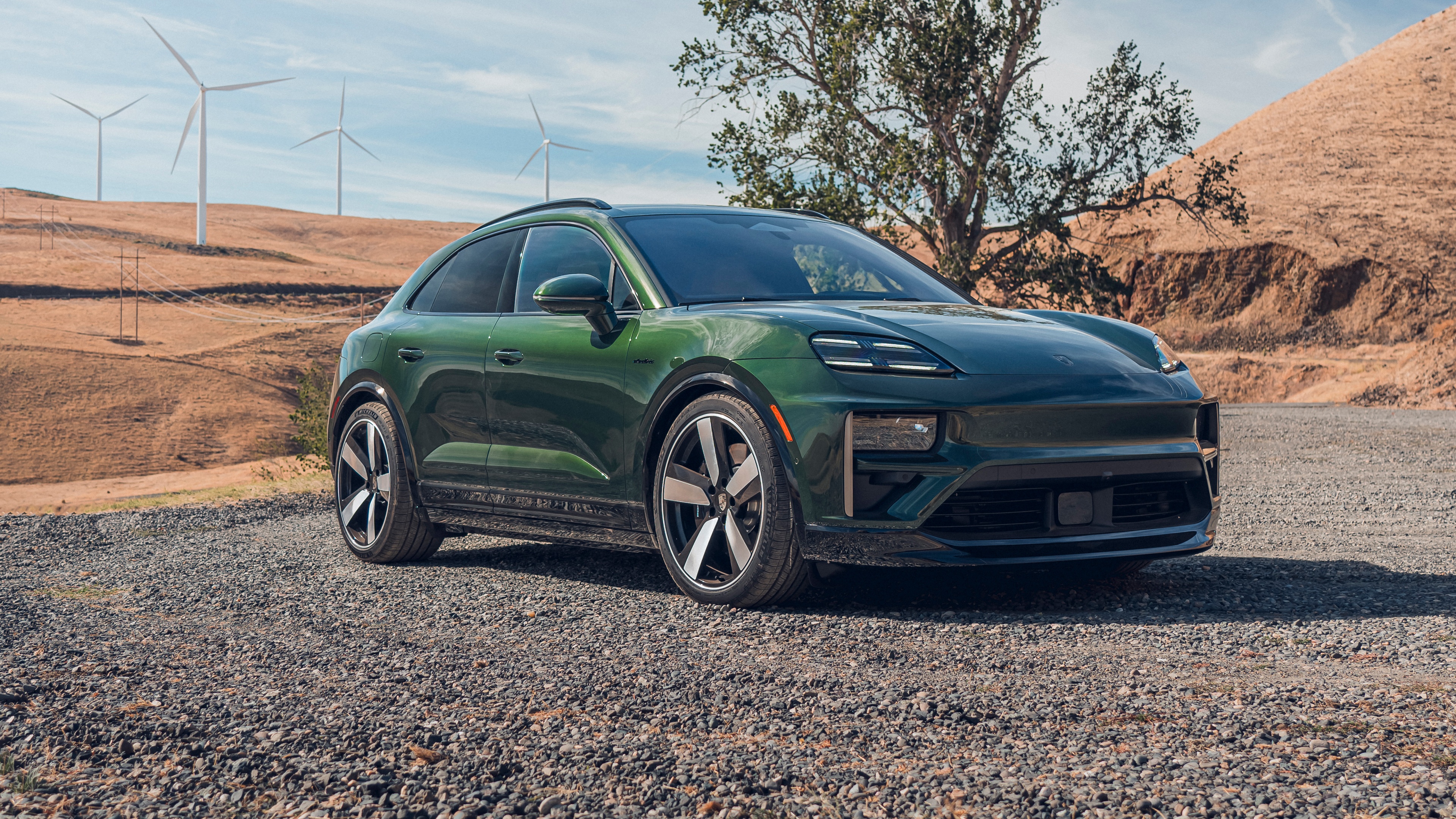 A detailed, high-quality view of the 2025 Porsche Macan Turbo, featuring its sleek metallic finish and modern luxury SUV styling.