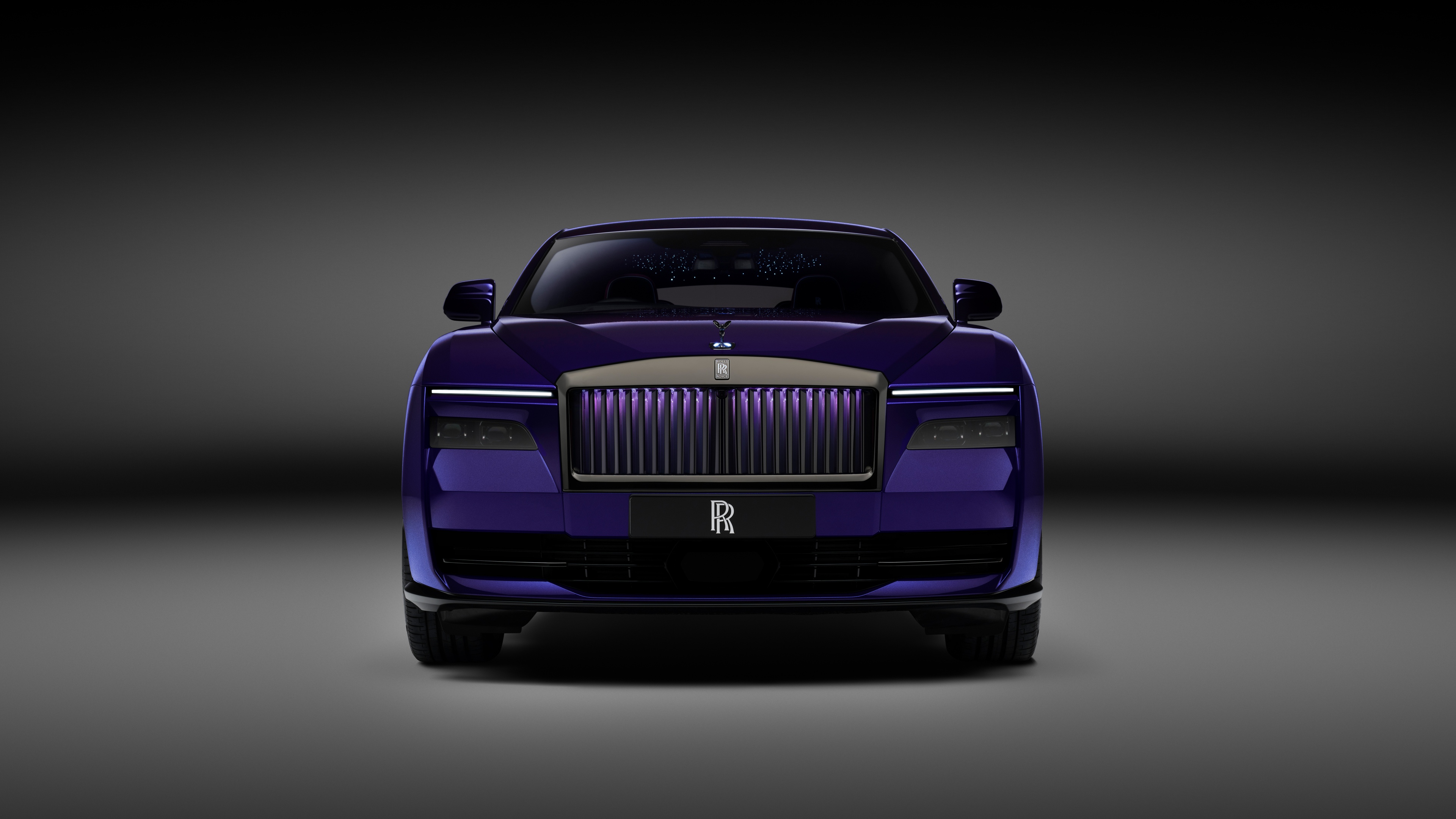 A sleek 2025 Rolls-Royce Black Badge Spectre displayed against a dark, aesthetic background.