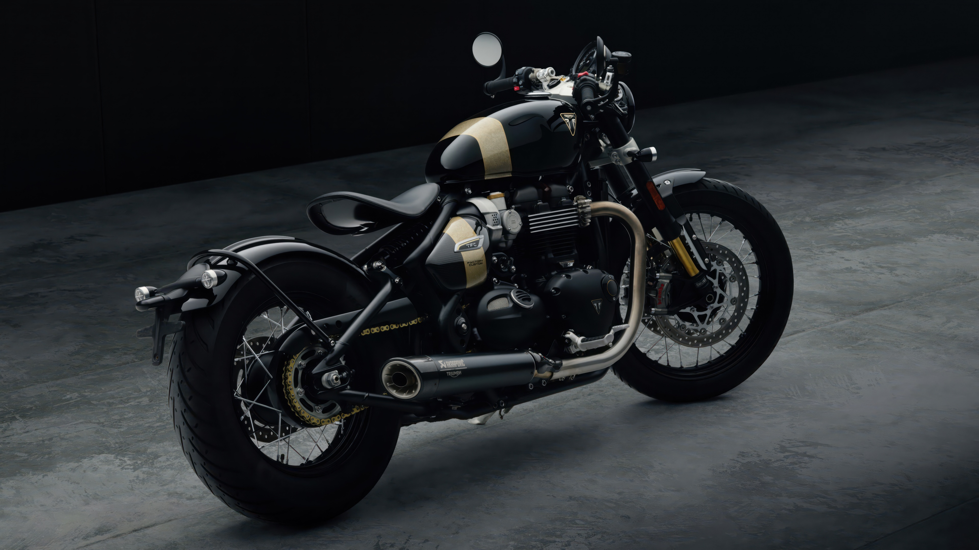 A high-resolution 5K close-up of the 2025 Triumph Bonneville Bobber TFC cruiser motorcycle against a dark, moody background.