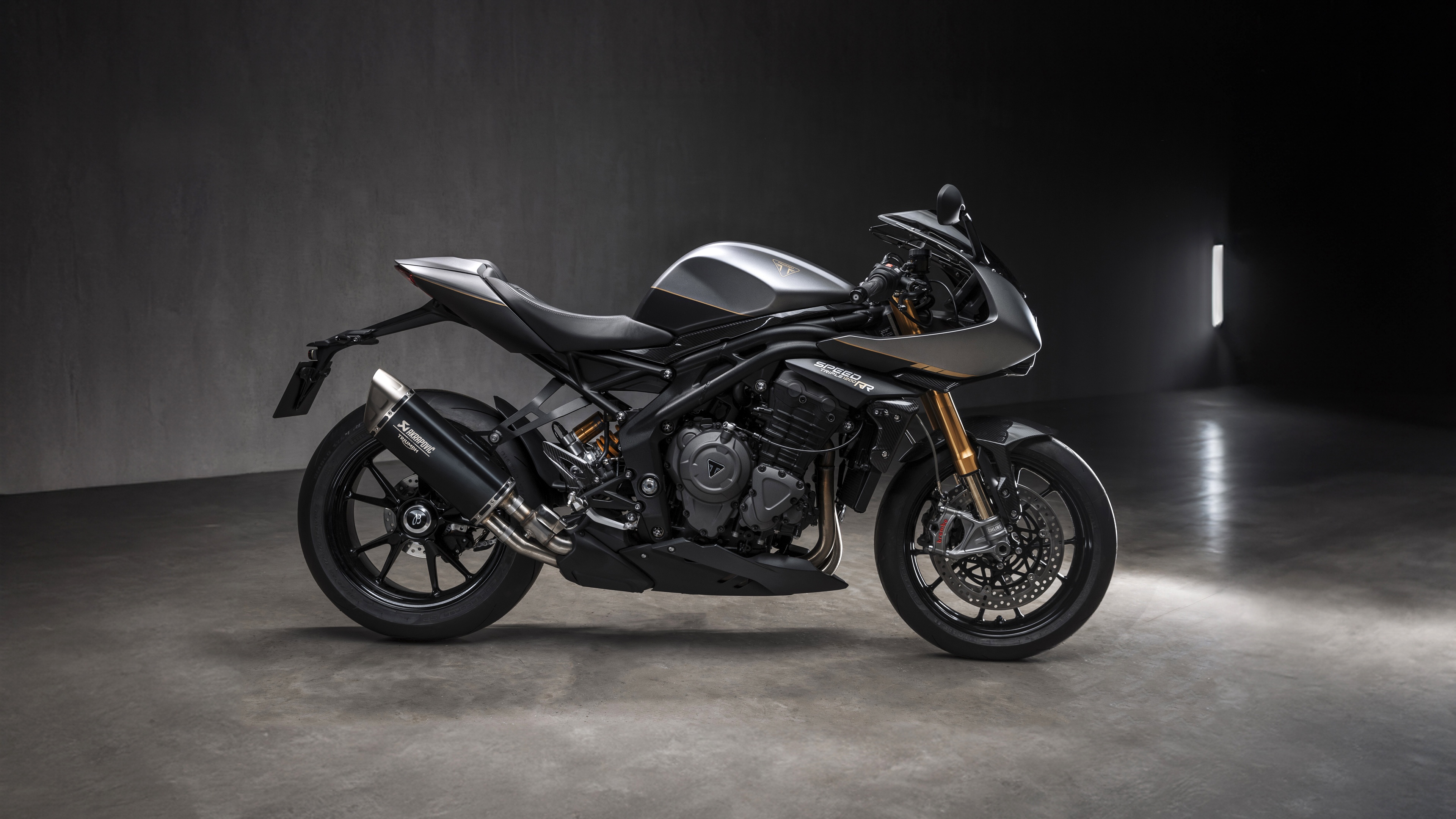 A high-resolution, close-up shot of the 2025 Triumph Speed Triple motorcycle featuring sleek metallic bodywork and modern streetfighter aesthetics.
