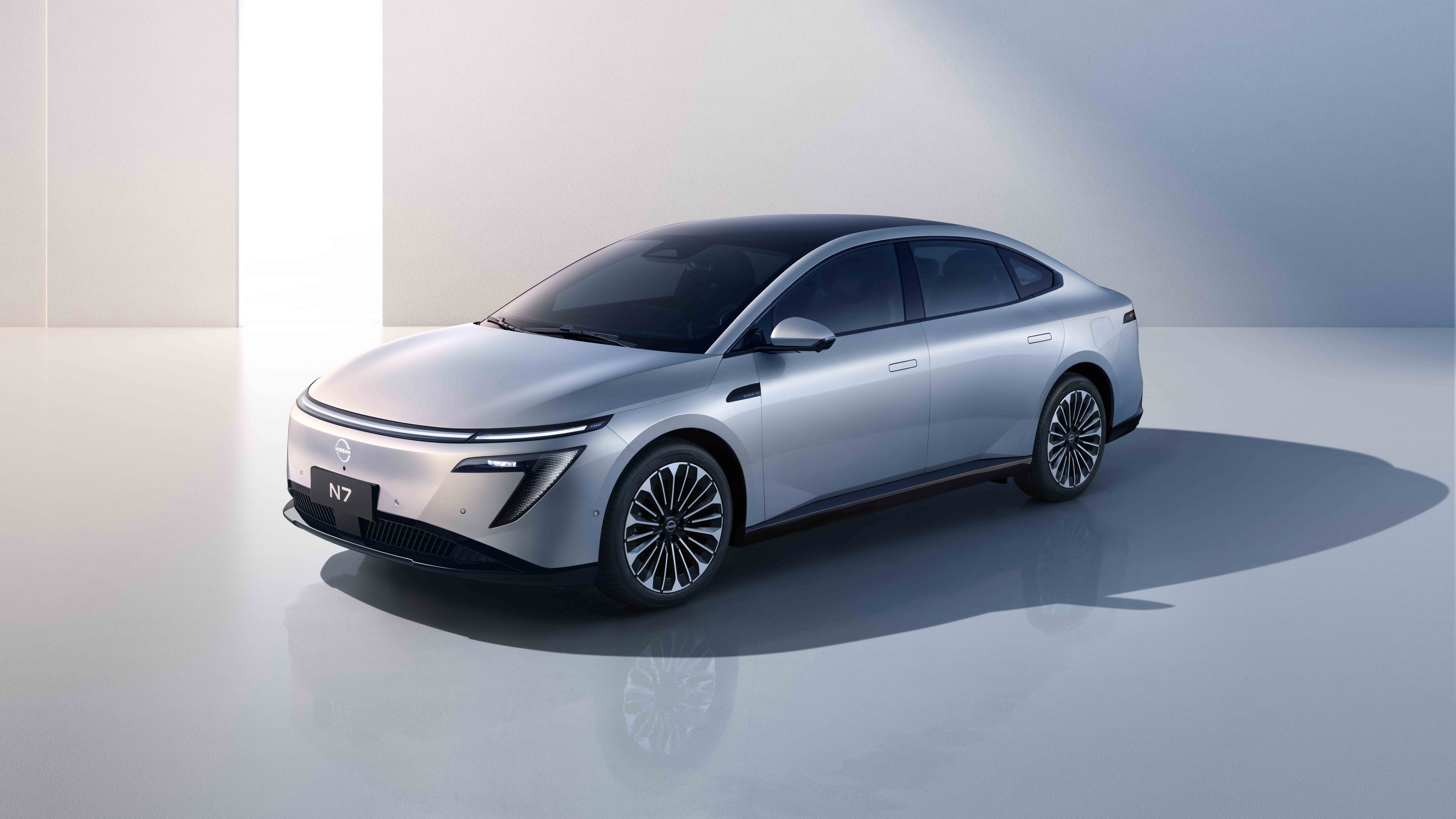 A sleek, metallic 2025 electric sedan with aerodynamic curves and bright LED headlights.