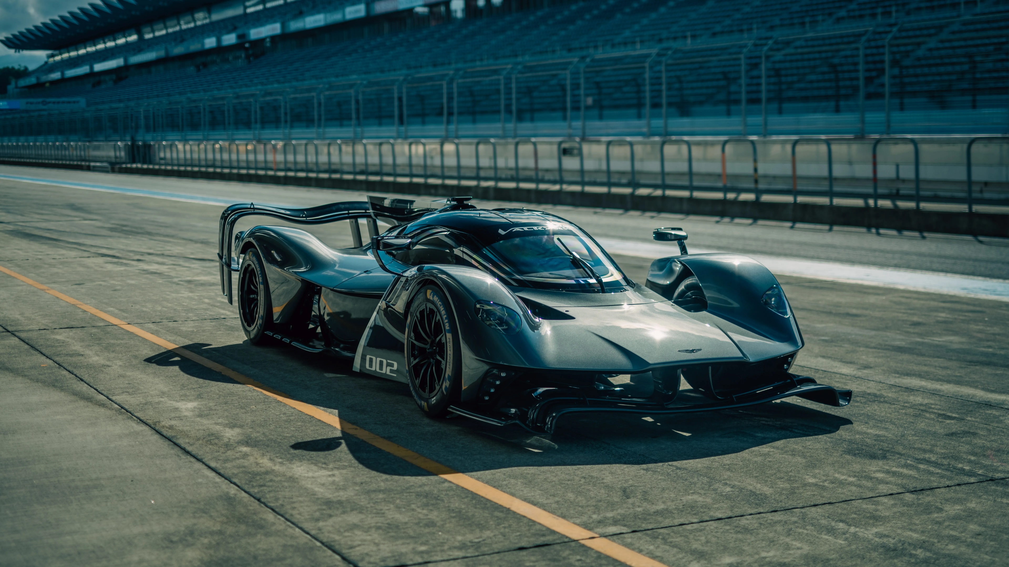 Aston Martin Valkyrie AMR Pro hypercar speeding on a professional race track.