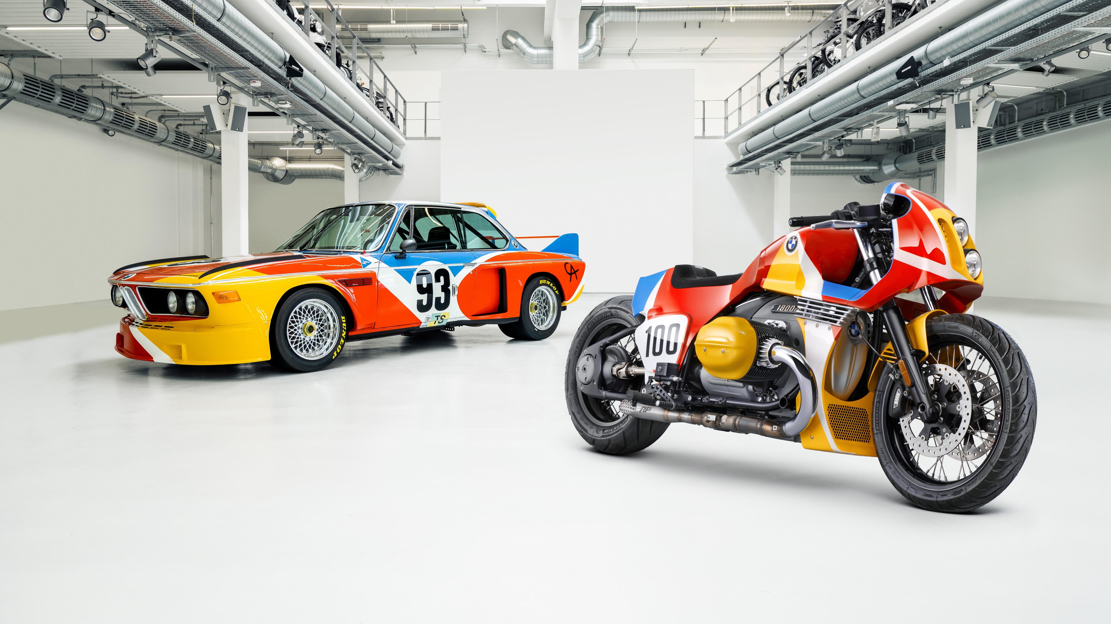 An intricately detailed BMW 1.8 CSL art vehicle featuring vibrant, multi-colored psychedelic patterns and complex graphic designs.