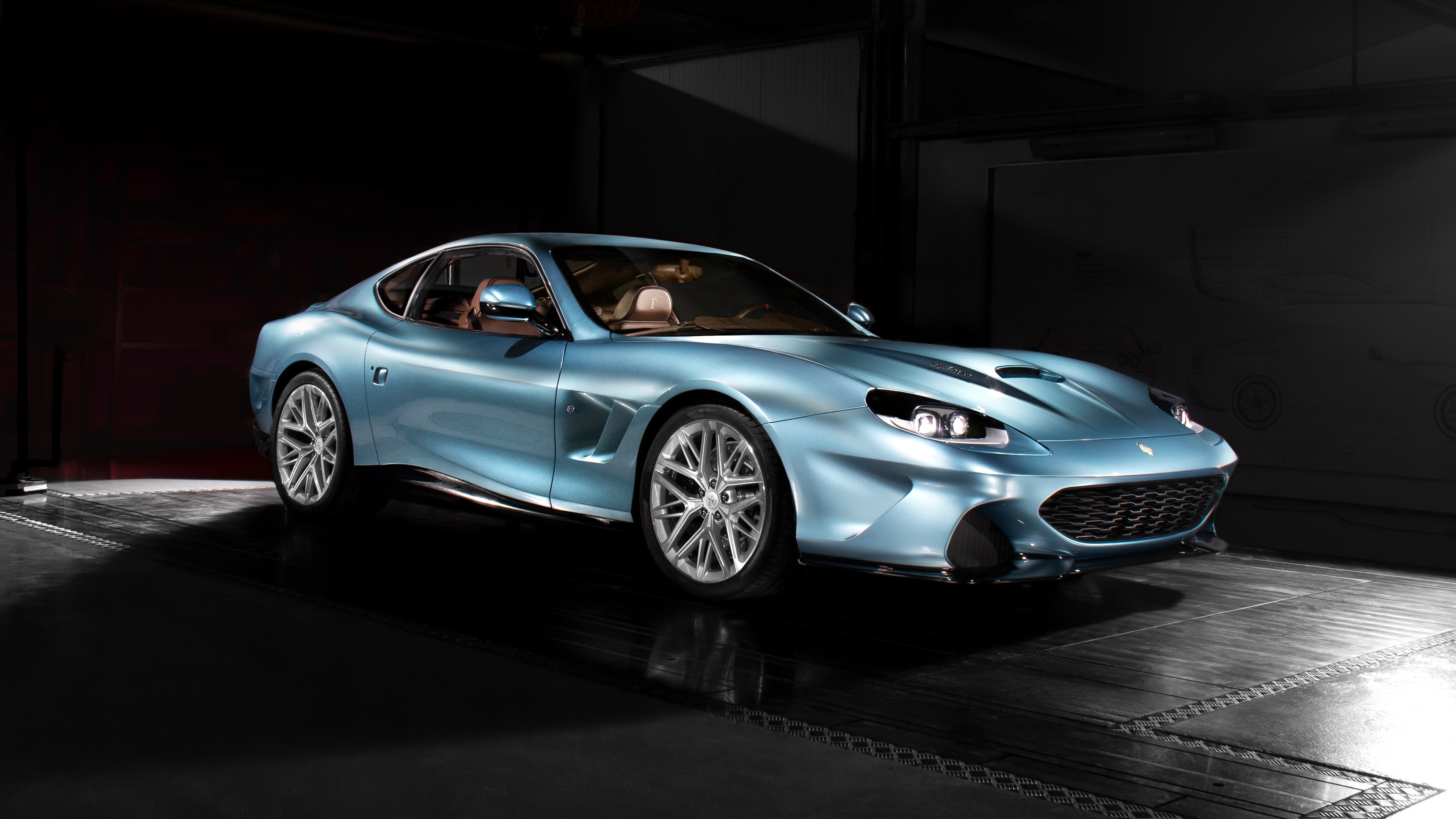High-resolution view of futuristic sports cars with dramatic lighting and sleek metallic finishes on a dark background.