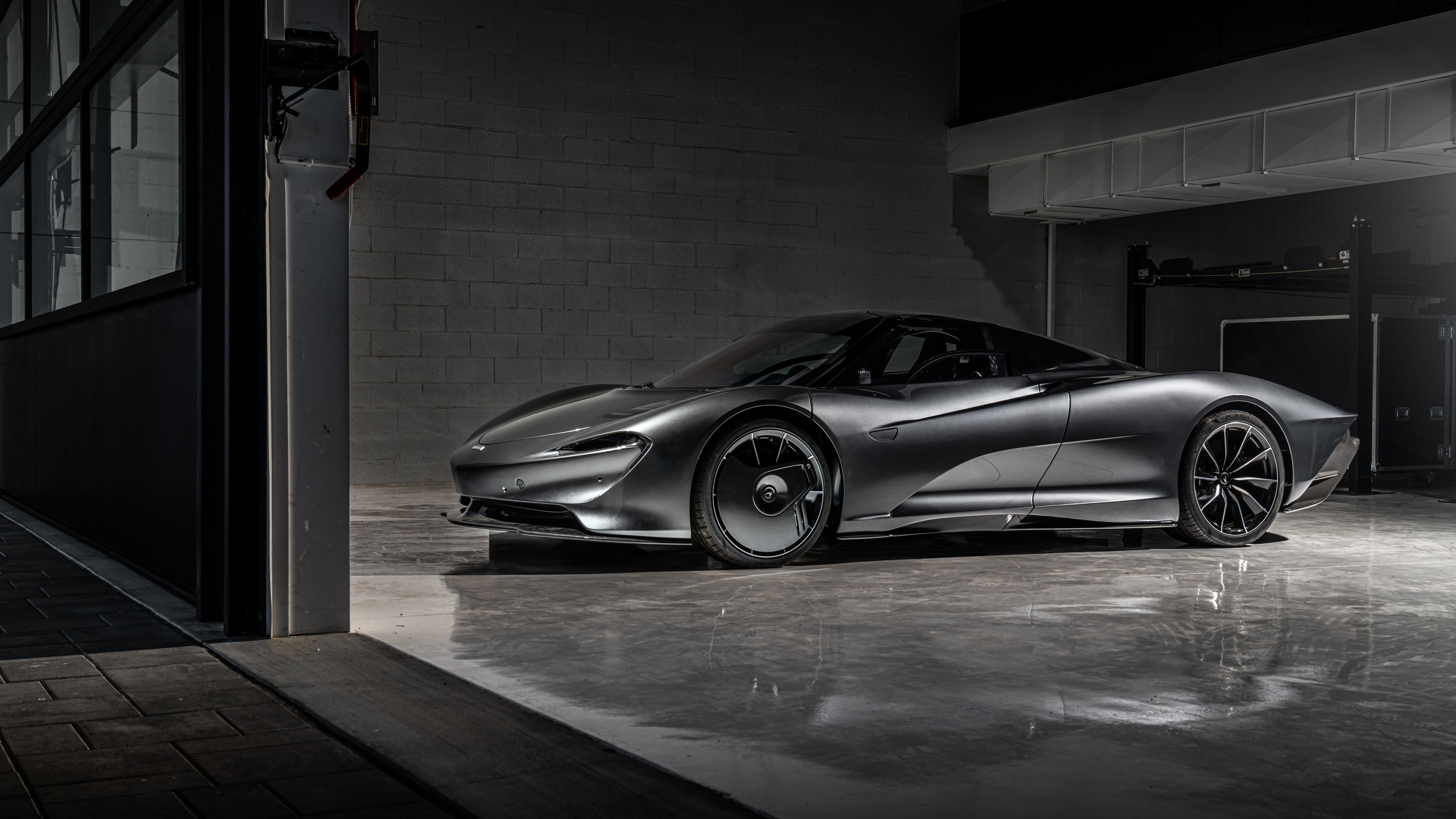 A high-resolution, dark-themed shot of the McLaren Speedtail hypercar showcasing its aerodynamic design and sleek silhouette.