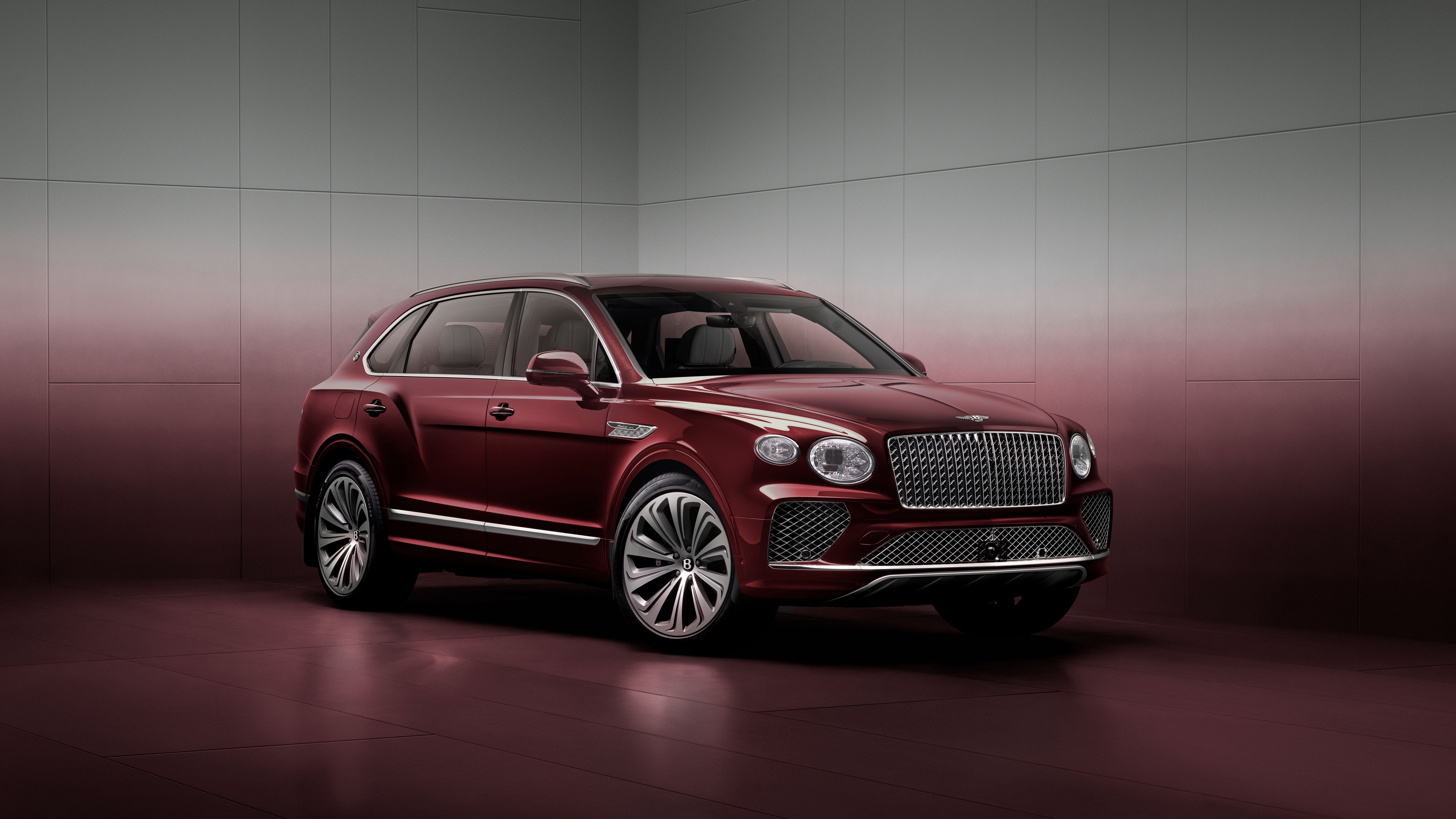 A high-resolution, luxurious view of a red 2025 Bentley Bentayga EWB Mulliner SUV with a deep red aesthetic.