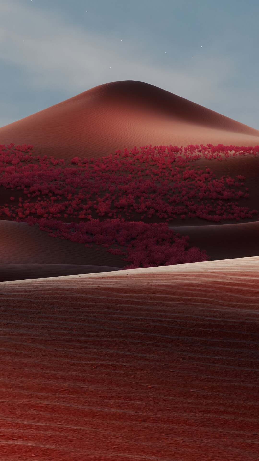 Cinematic view of deep red sand dunes in a warm, dreamlike desert landscape.