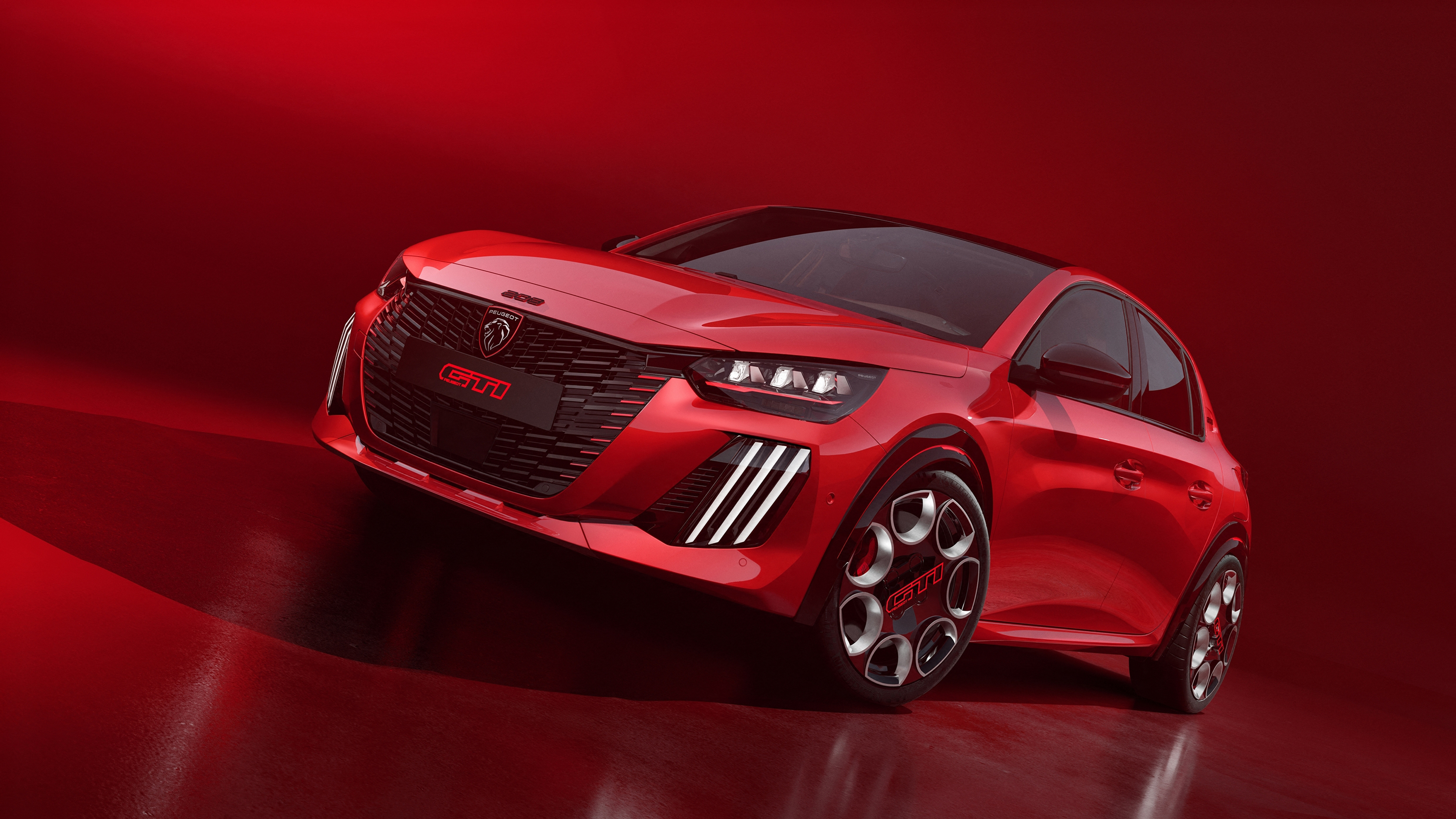 A group of sleek, modern red cars arranged against a solid, vibrant red background, showcasing futuristic automotive design.