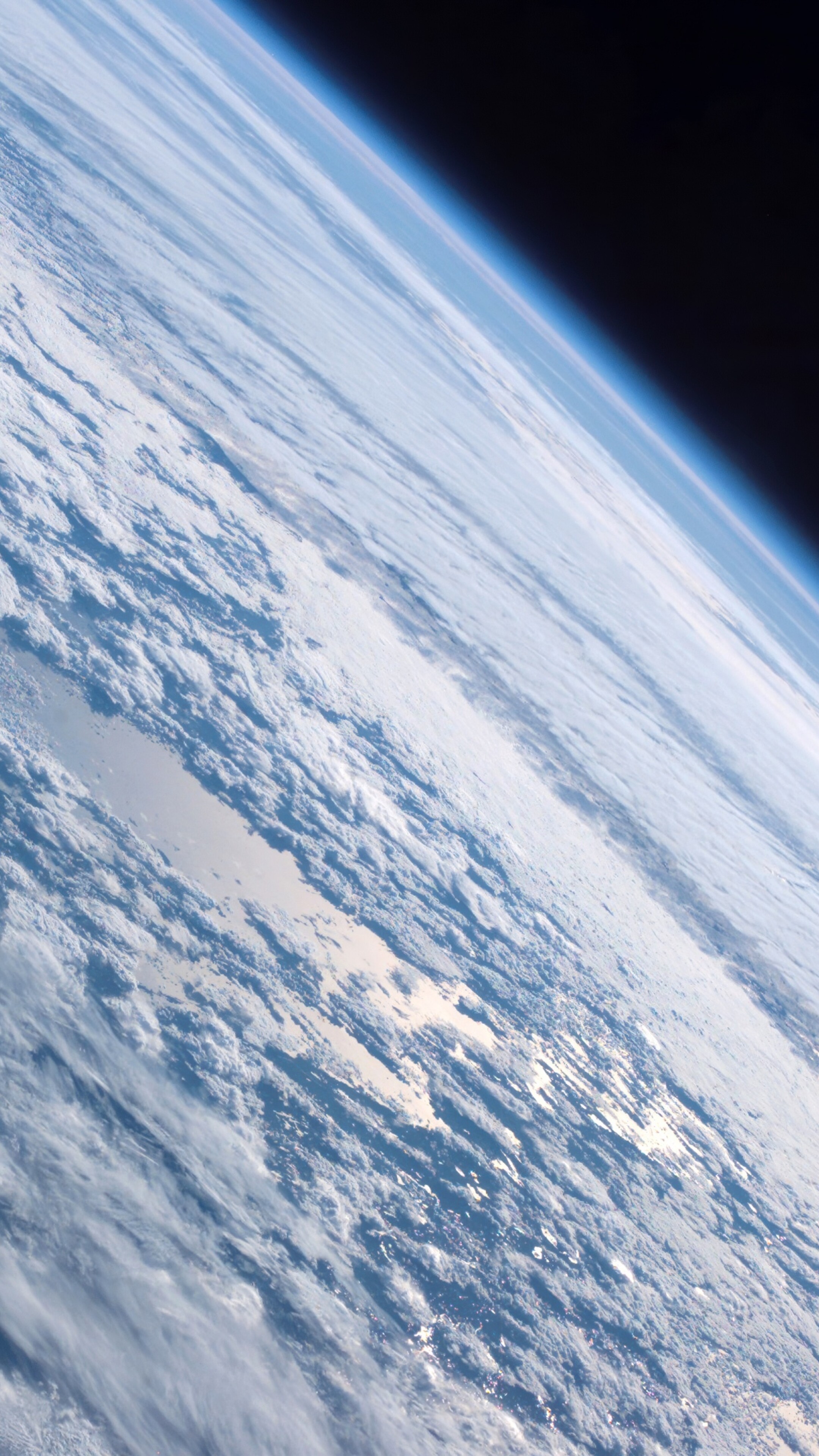 A high-resolution 5K cinematic view of Planet Earth in orbit, styled after the iconic Mac OS X Mountain Lion wallpaper.