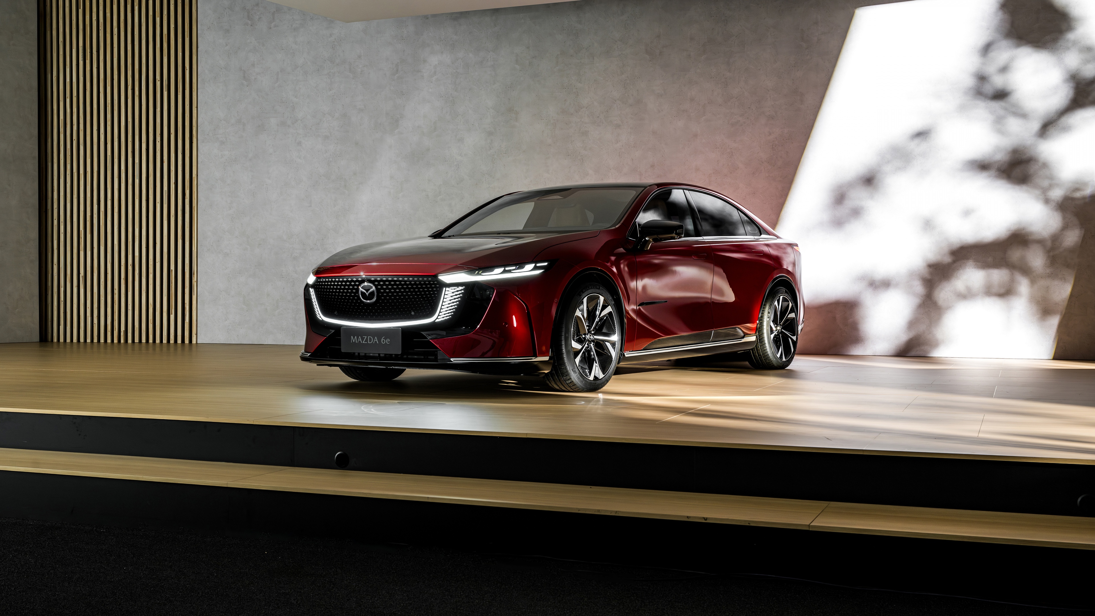 A sleek, modern 2025 electric sedan featuring aerodynamic curves and futuristic LED headlights