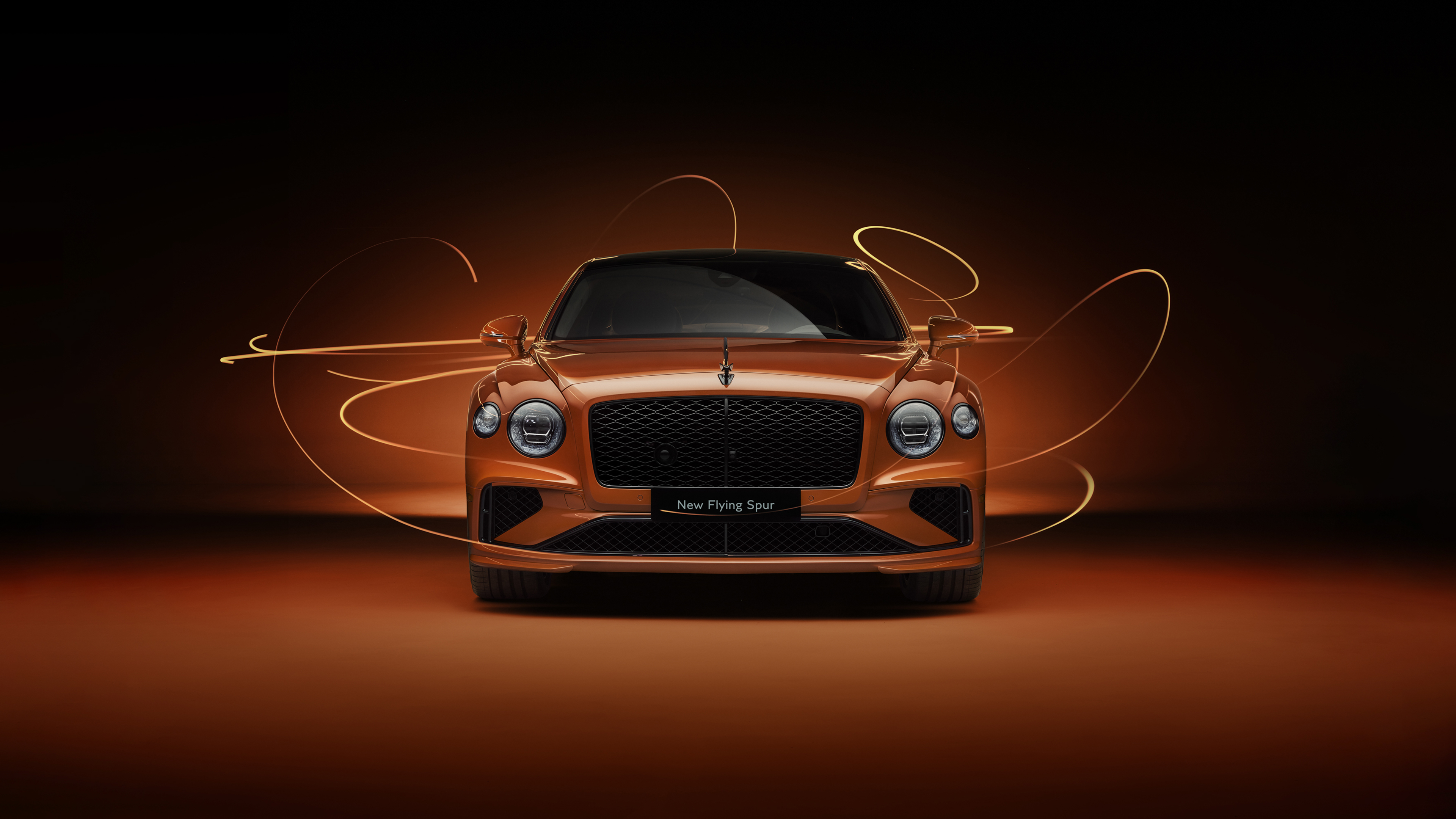 A luxury Bentley Flying Spur automobile featuring a vibrant orange aesthetic and warm lighting.