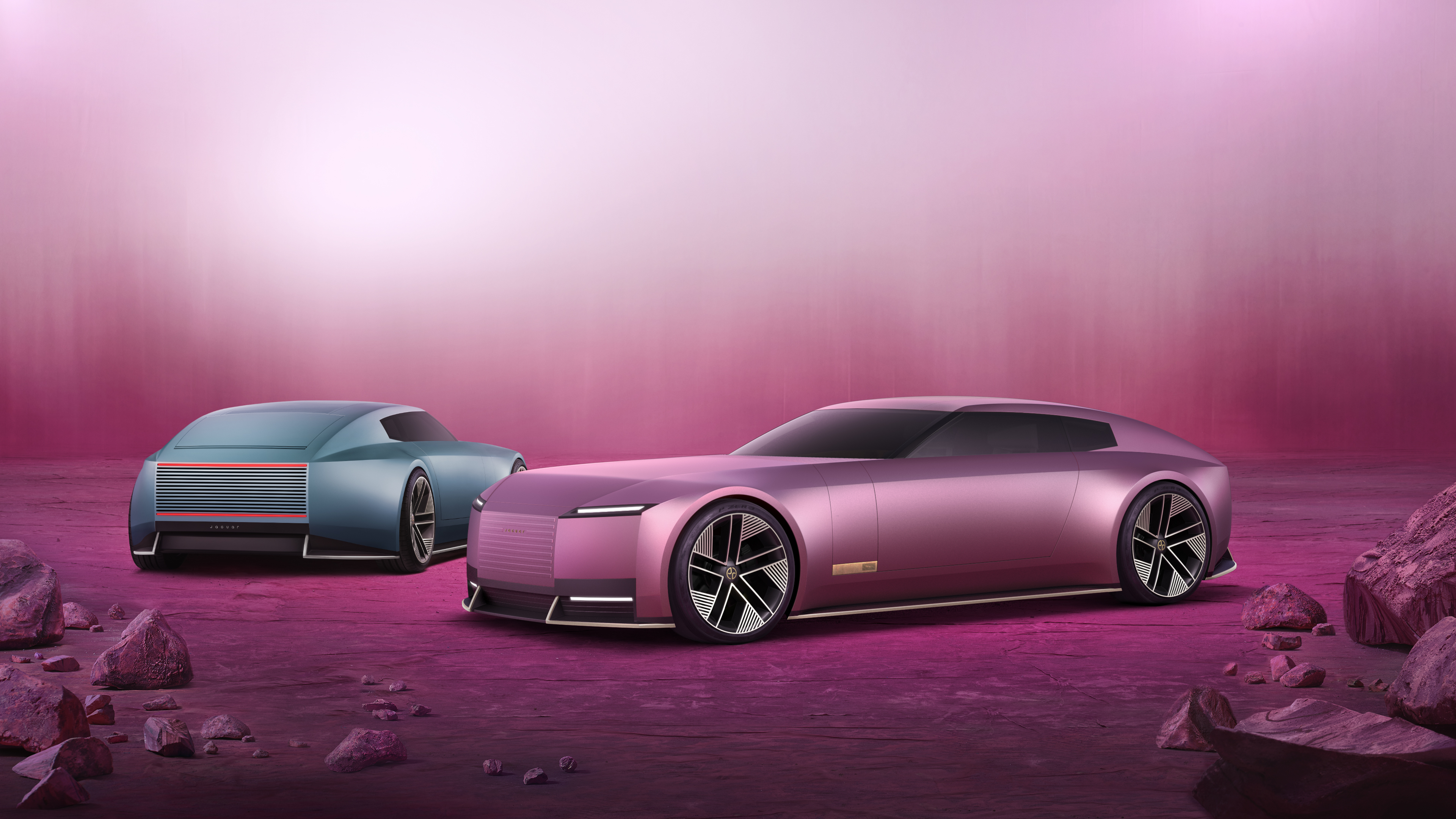 A futuristic Jaguar Type 00 concept car set against a monochromatic pink background.
